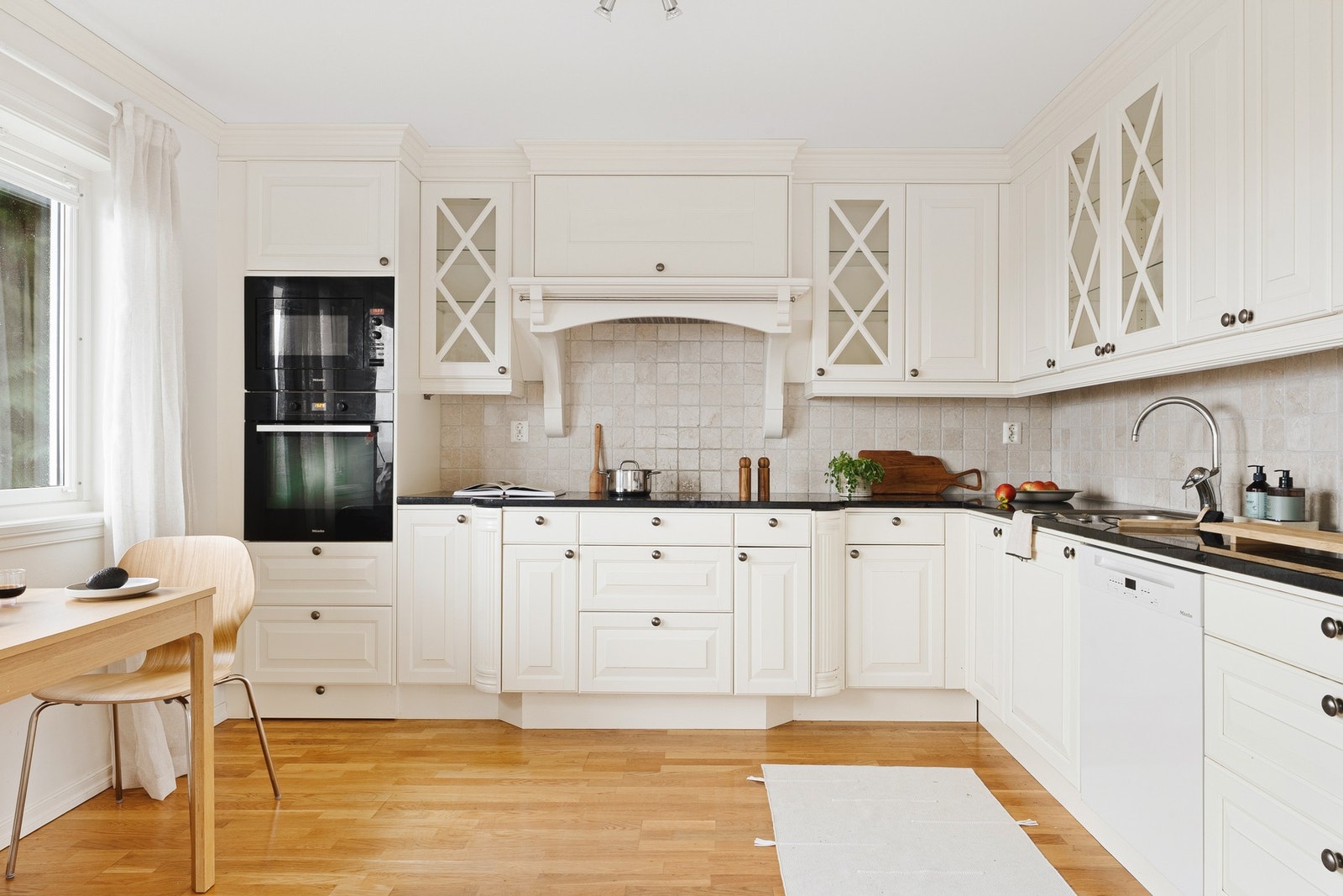 Kjøkkenet er adskilt fra stue og spisestue, og er innredet med kjøkkeninnredning fra Drømmekjøkken med malte fyllingsfronter og benkeplate i granitt med nedfelt stålvask. Galleribilde