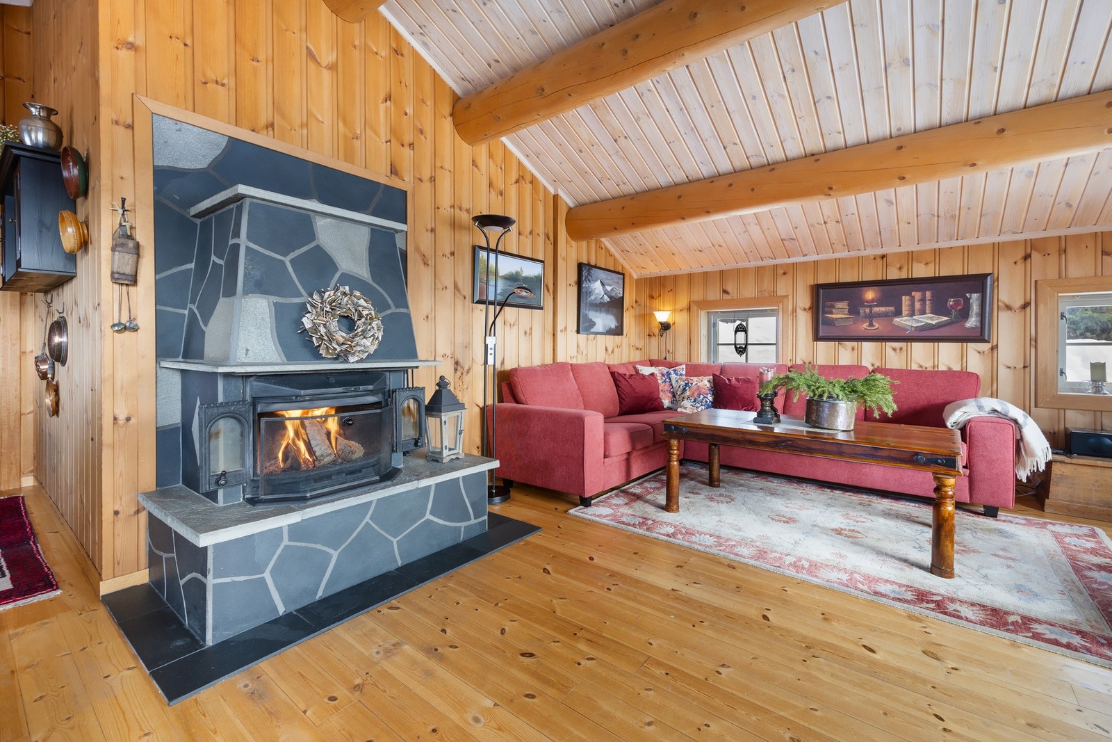 Midt i rommet står en flott skiferbelagt peis som sprer varme og skaper en hyggelig atmosfære. Galleribilde