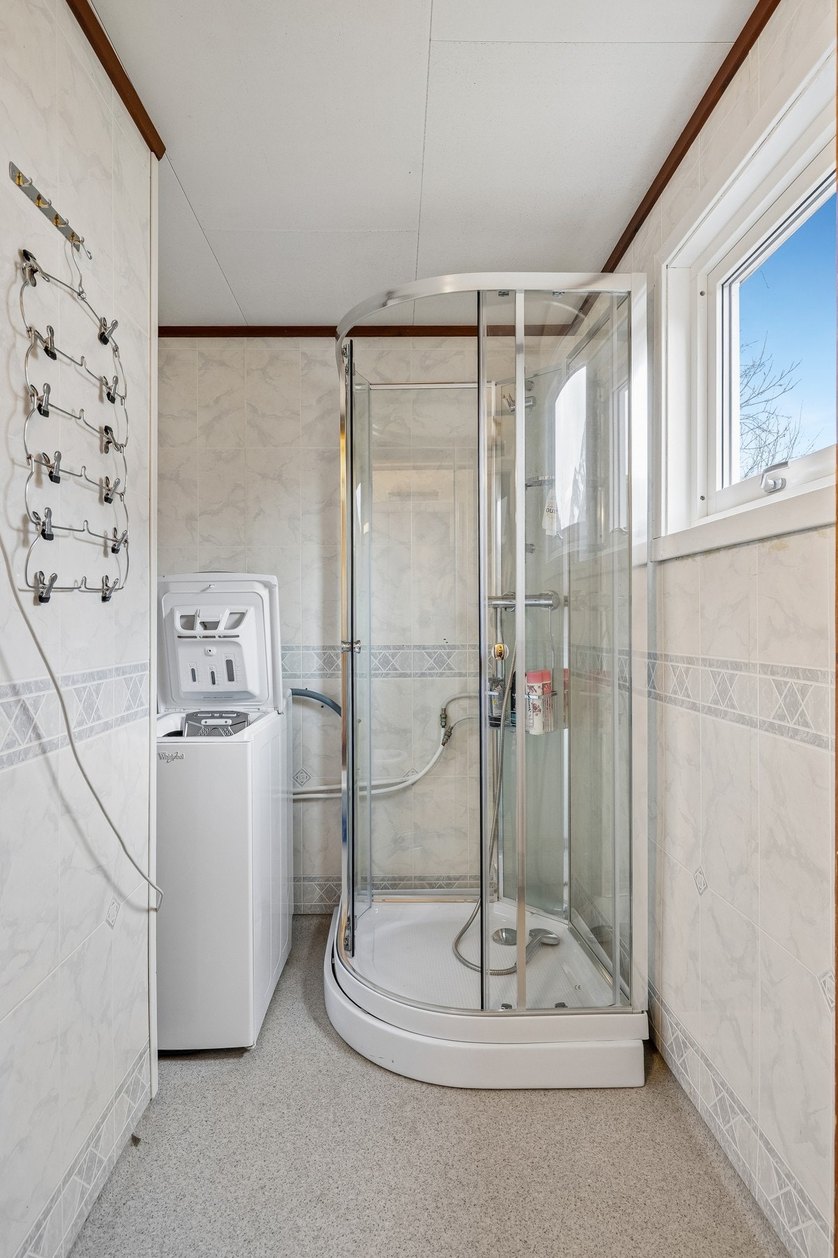 Rommet har belegg på gulvet og baderomsplater på vegger. Galleribilde