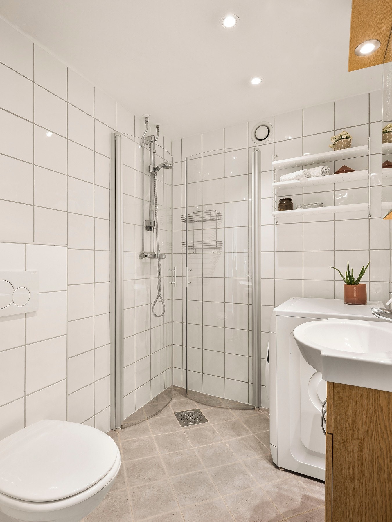 Det består av vegghengt toalett, servantskap, dusjhjørne og opplegg til vaskemaskin. Det er naturligvis varme i gulvet også. Galleribilde