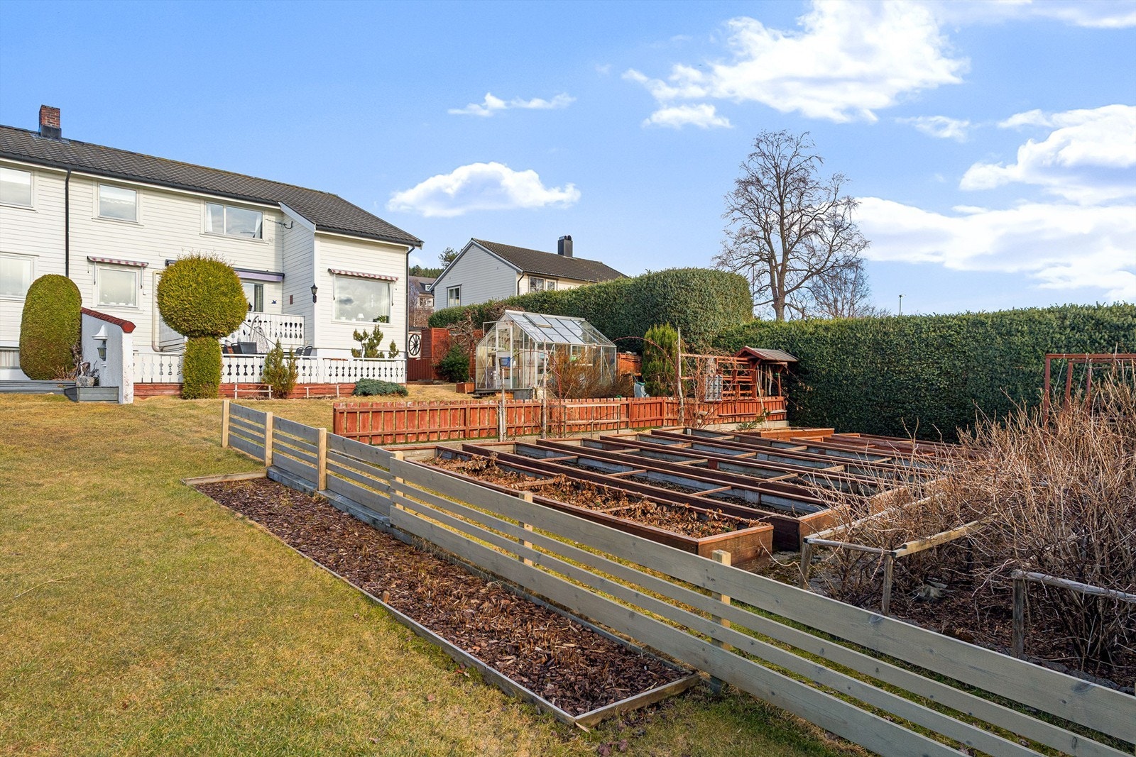 Eiendommen er opparbeidet med plen, beplantning, treplattinger og grønnsaksåker. Galleribilde