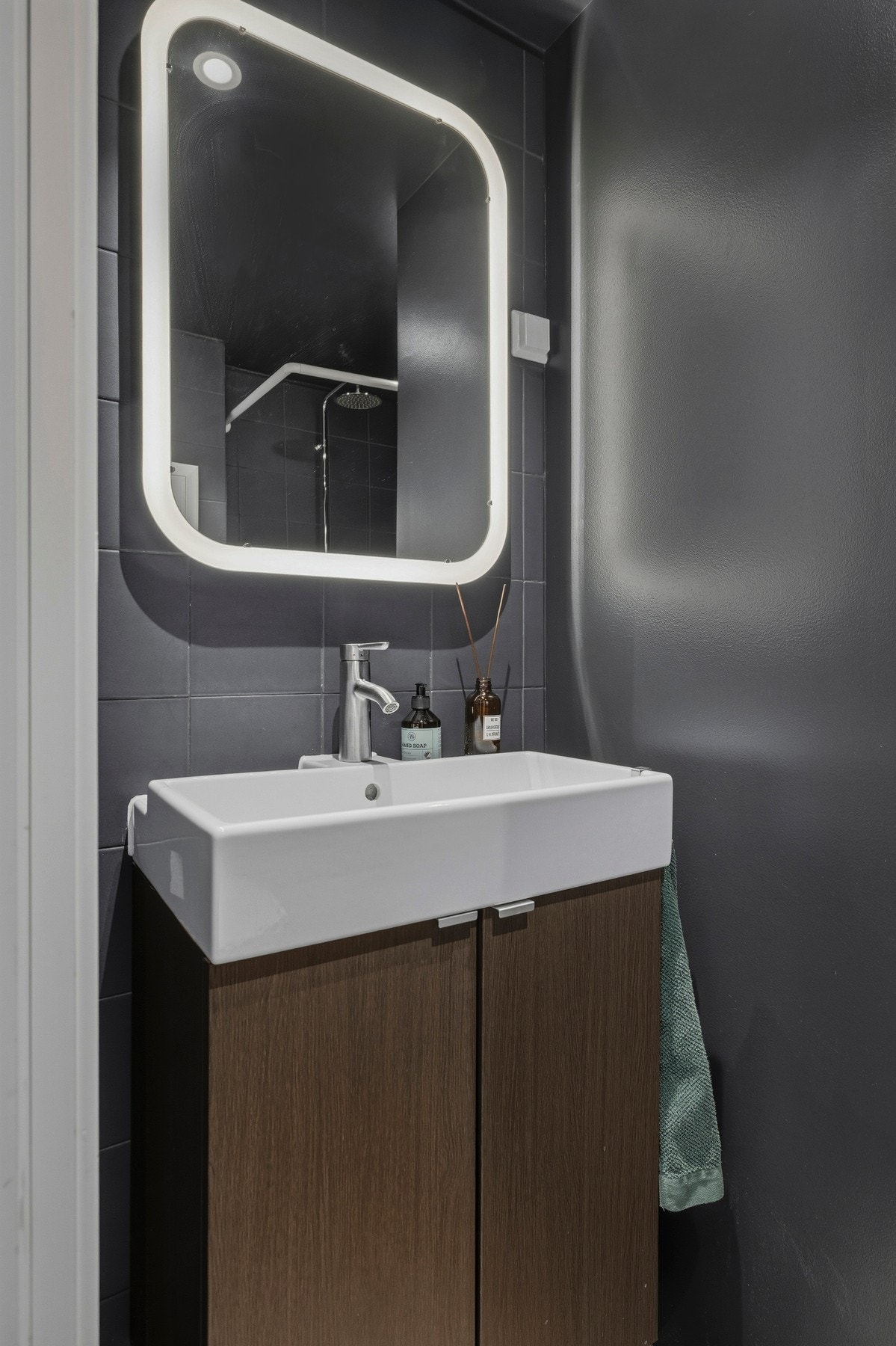 Innredningen består av skap med glatte fronter og et speil med integrert lys Galleribilde