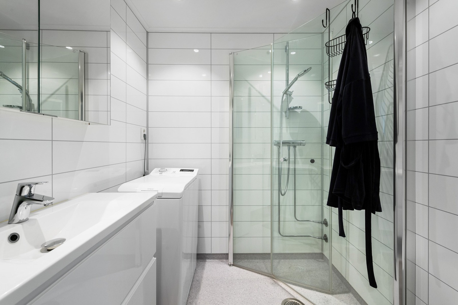 Badet har vinylbelagt gulv med vannbåren varme, samt eklektiske varmekabler. Baderomsinnredning med nedfelt servant, vegghengt toalett og dusjvegger, samt opplegg for vaskemaskin. Galleribilde