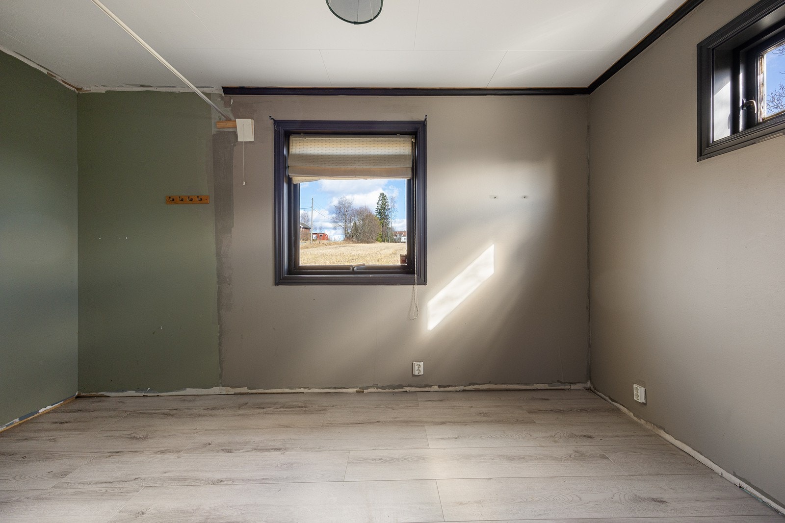 Soverommet har store vinduer som sørger for rikt, naturlig lysinnslipp, og det er påbegynt oppussing av overflatene. Galleribilde