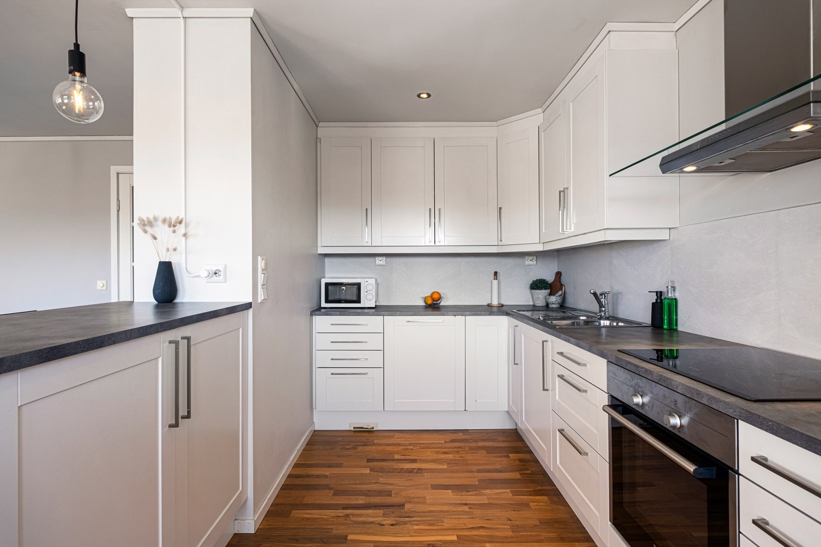 Det er barbenk med sitteplasser mellom kjøkken og stue. Galleribilde