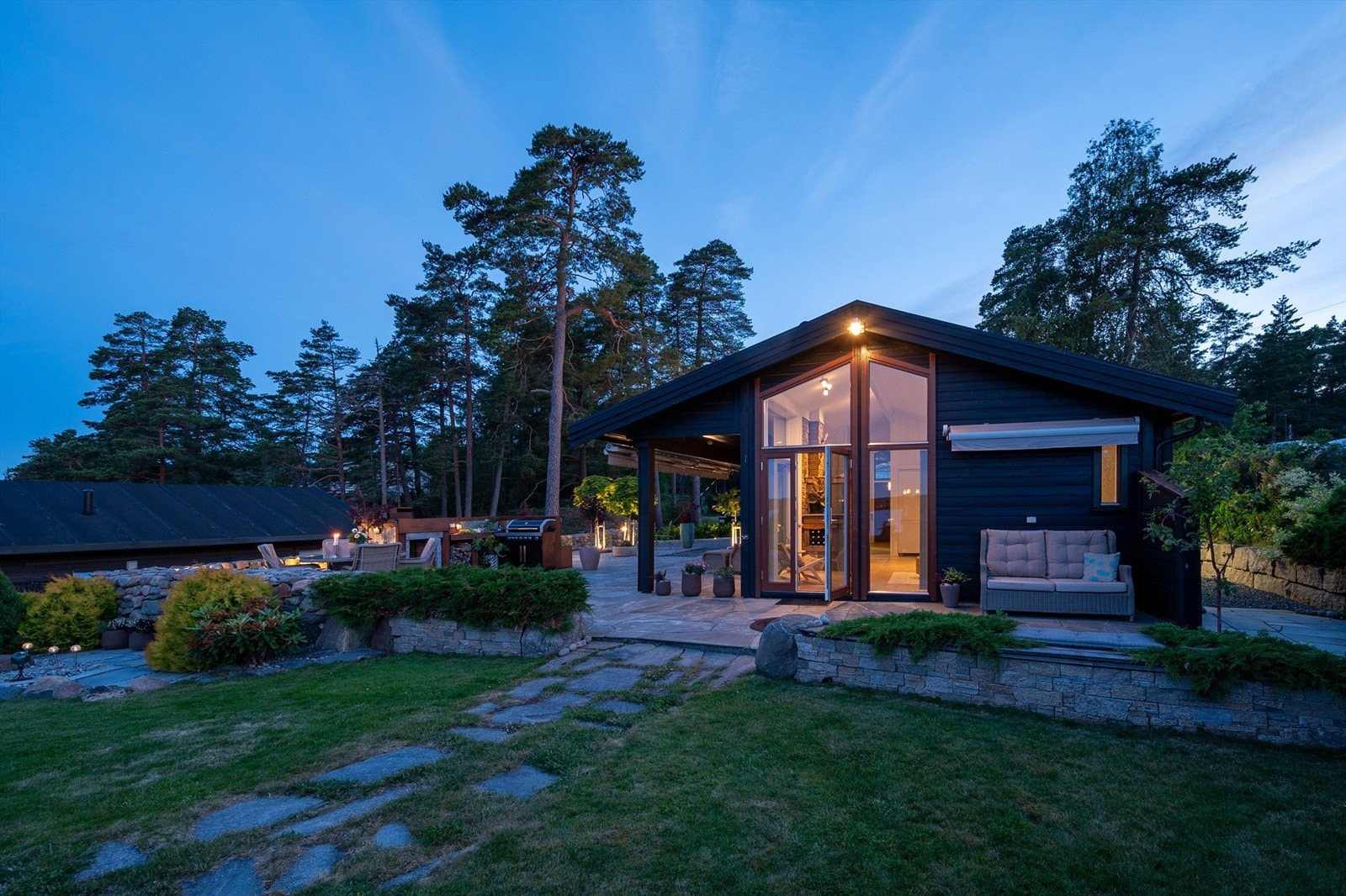 Ulike soner og uteplasser gir stor valgfrihet. 150 kvm. vedlikeholdsfri skifer- og brosteinsplatting ble anlagt inntil hytta rundt 2019. Galleribilde