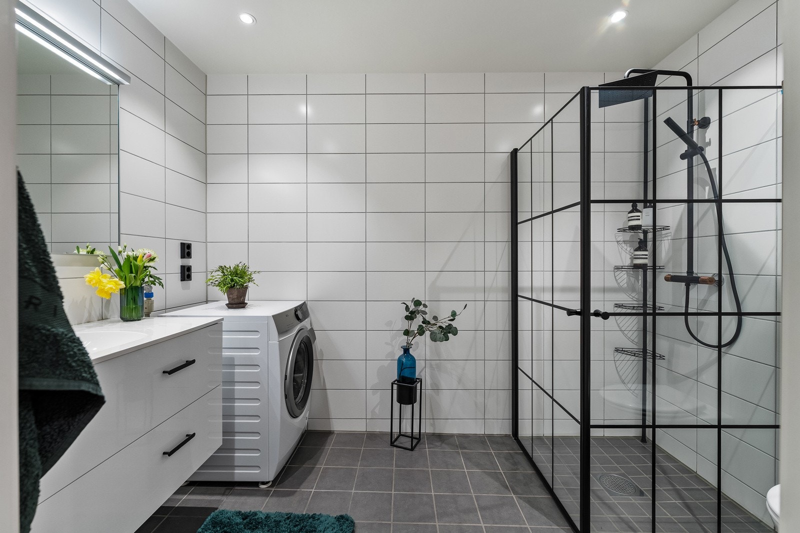 badet har moderne innredning med skuffer inkludert glatte fronter, veggfestet klosett med innebygget sisterne, servant og dusj med herdet glassdører. Galleribilde