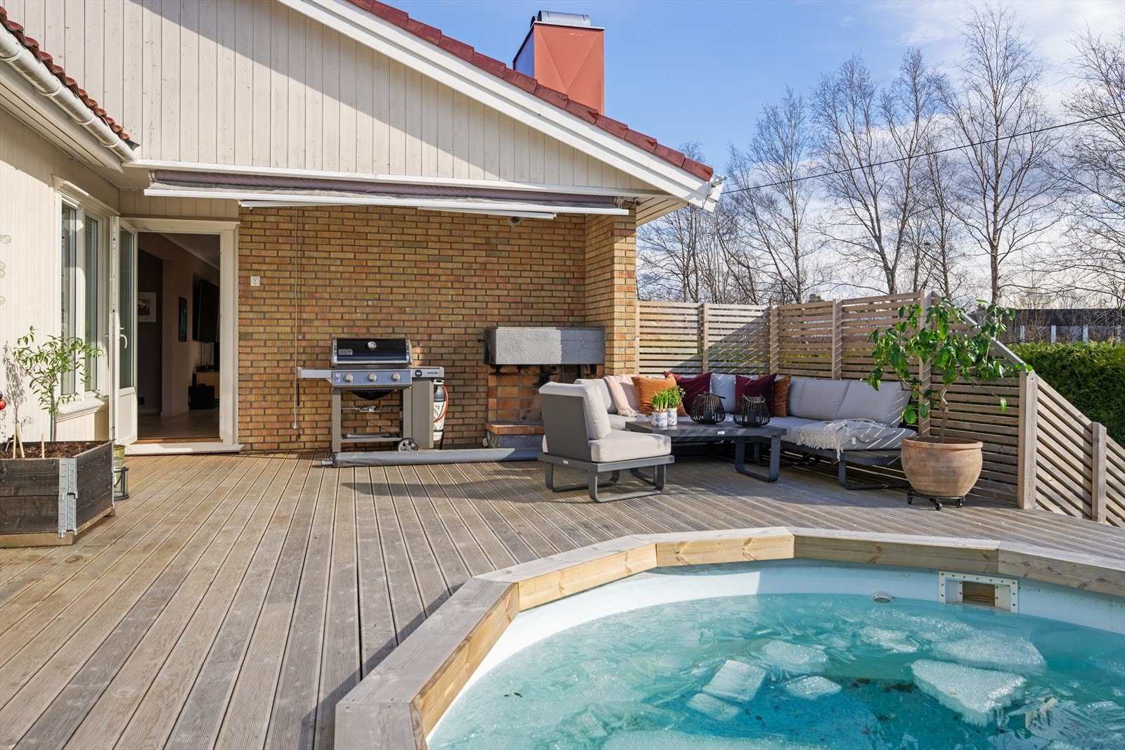 Uteplassen har en åpen peis, perfekt for kjølige kvelder. Ytterveggene ble tilleggsisolert og fikk ny kledning i perioden 2011-2014. Galleribilde