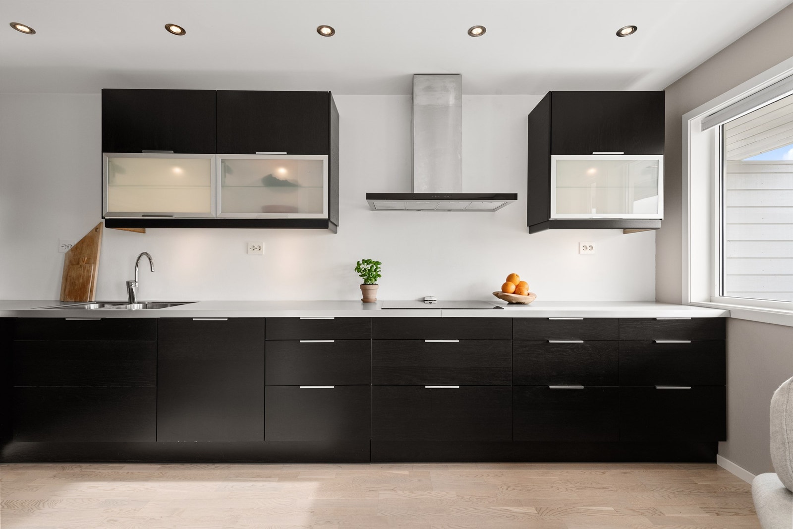 Leiligheten har en romslig, åpen stue- og kjøkkenløsning. Kjøkkenet har sorte, glatte fronter og rikelig med benkeplass. Galleribilde