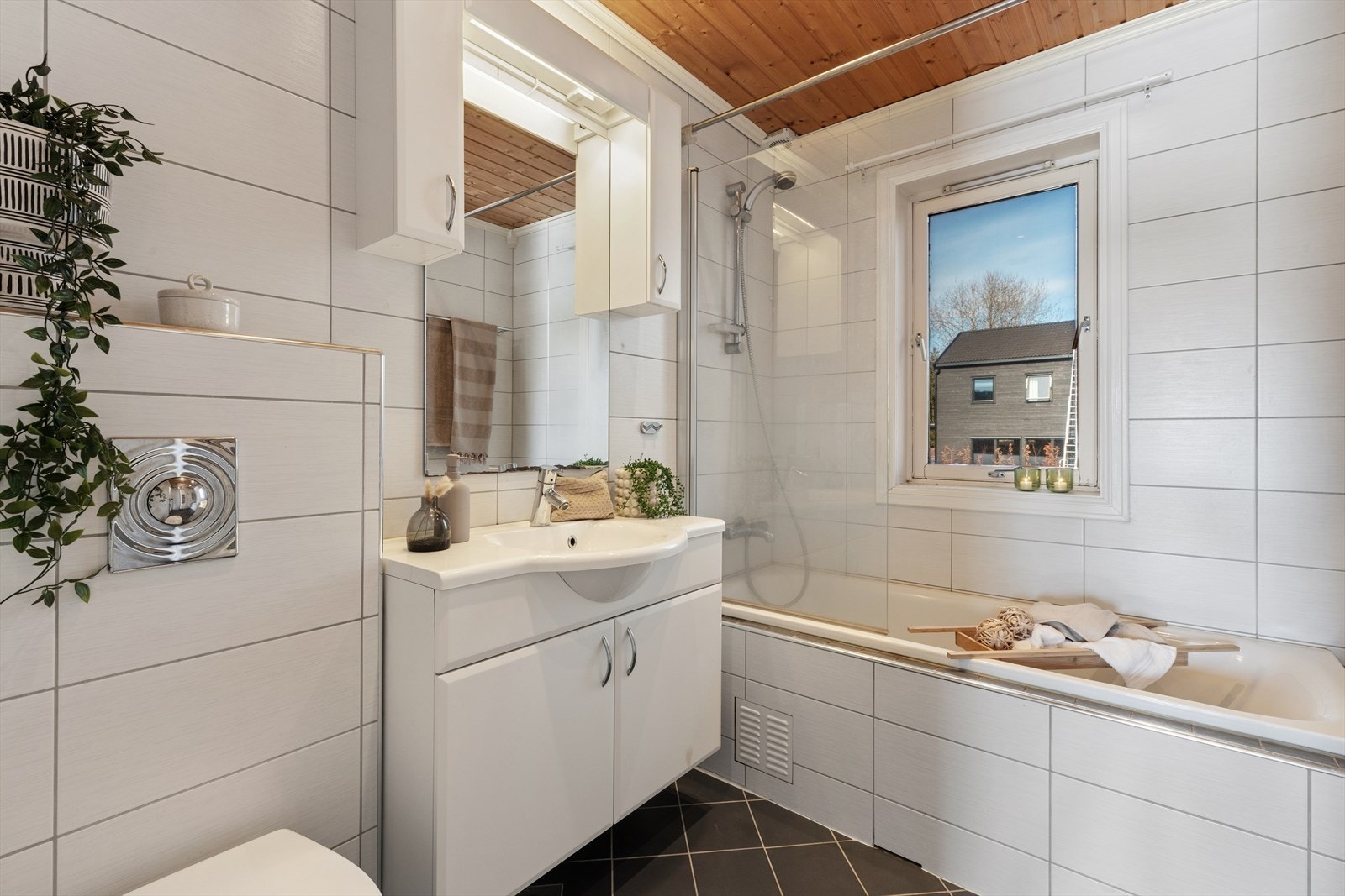 Baderom fra 2007 som har fliser på gulv og vegger, med elektriske varmekabler i gulvet for økt komfort. Galleribilde