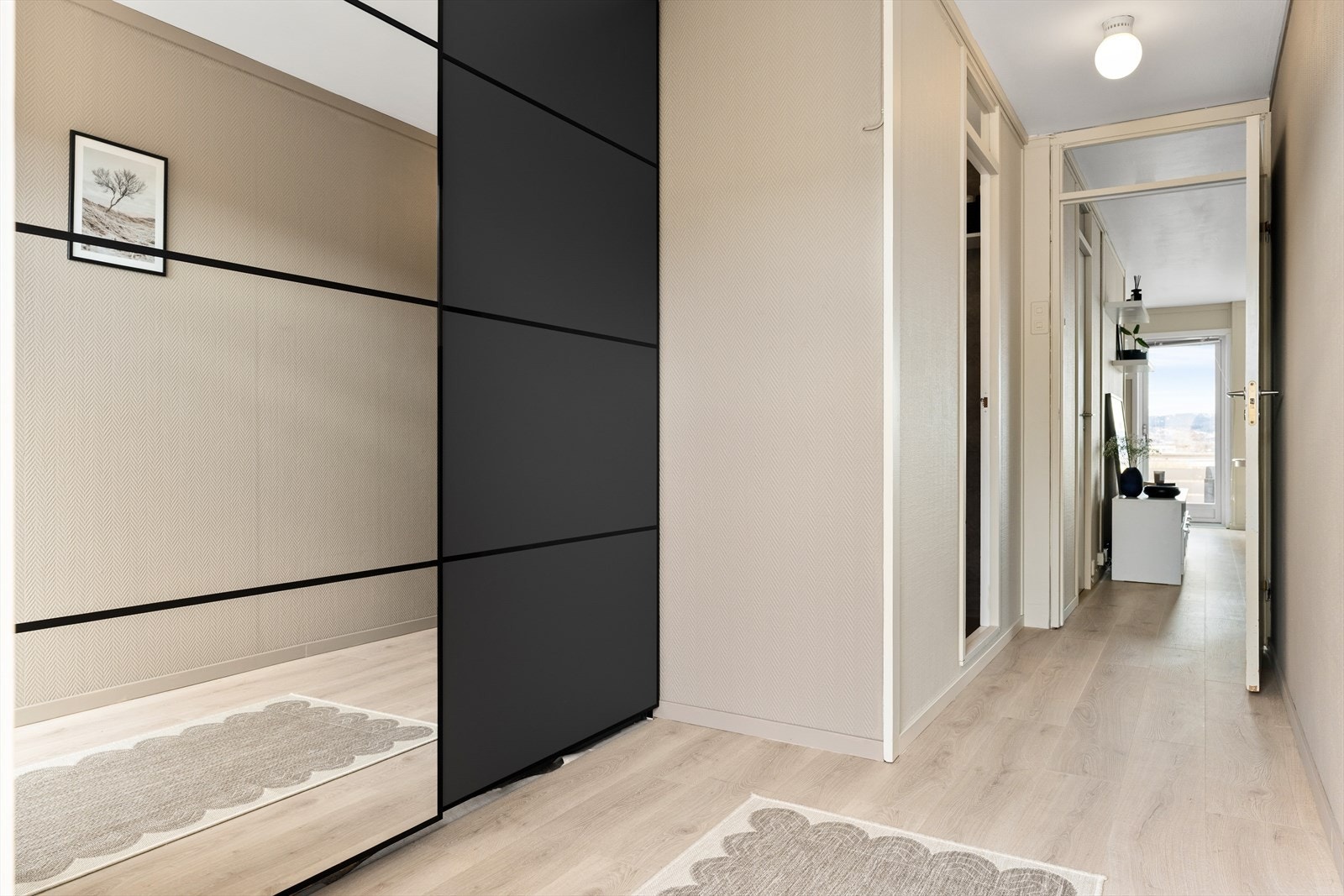 Her ønskes man velkommen inn til boligens romslige entré på ca. 7,5 m². Avbildet garderobeskap fra 2024 medfølger handelen. Fra entrén har man direkte tilgang til leilighetens bad. Galleribilde