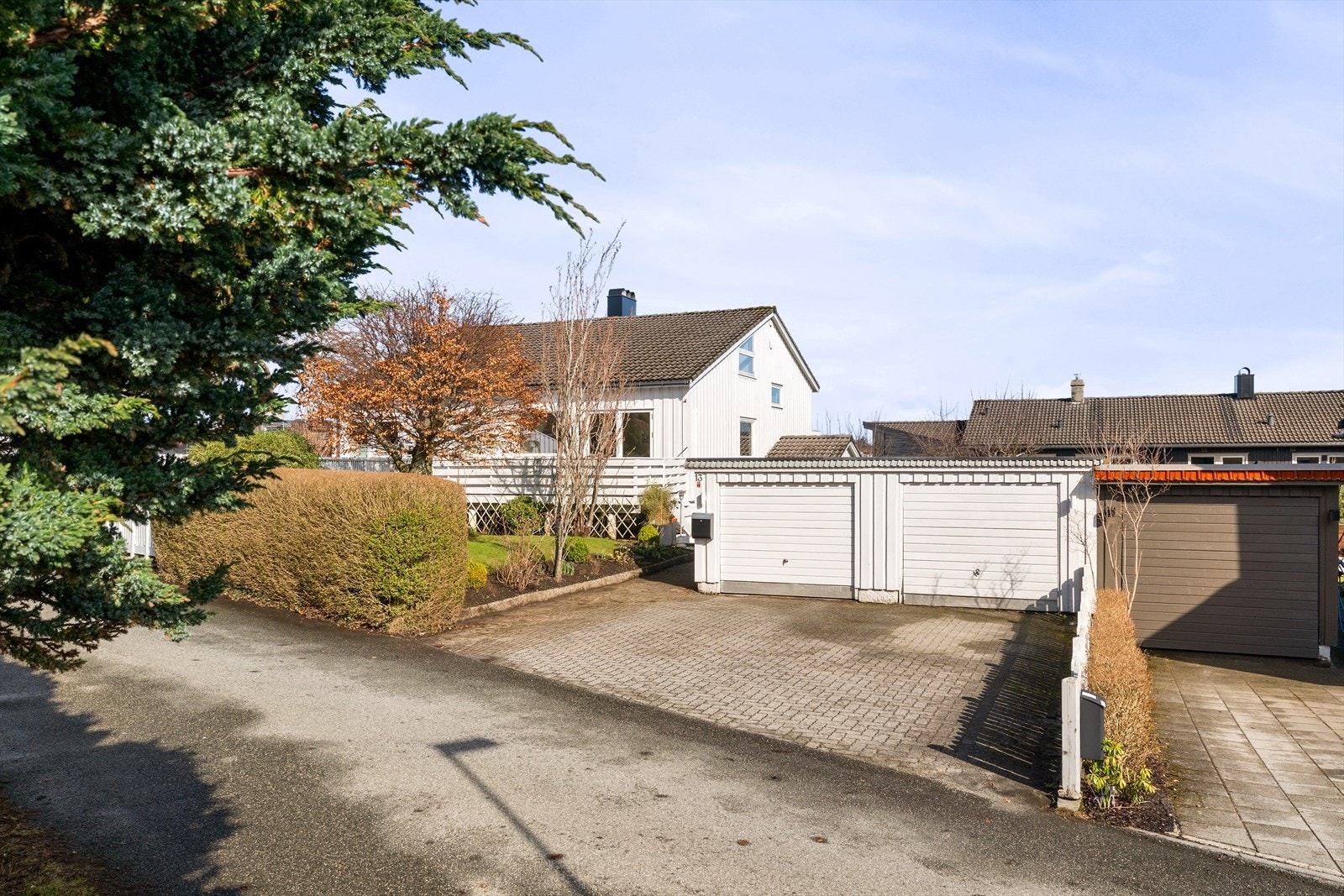 Oversiktlig og praktisk adkomst med romslig gårdsplass og flere parkeringsplasser. Galleribilde