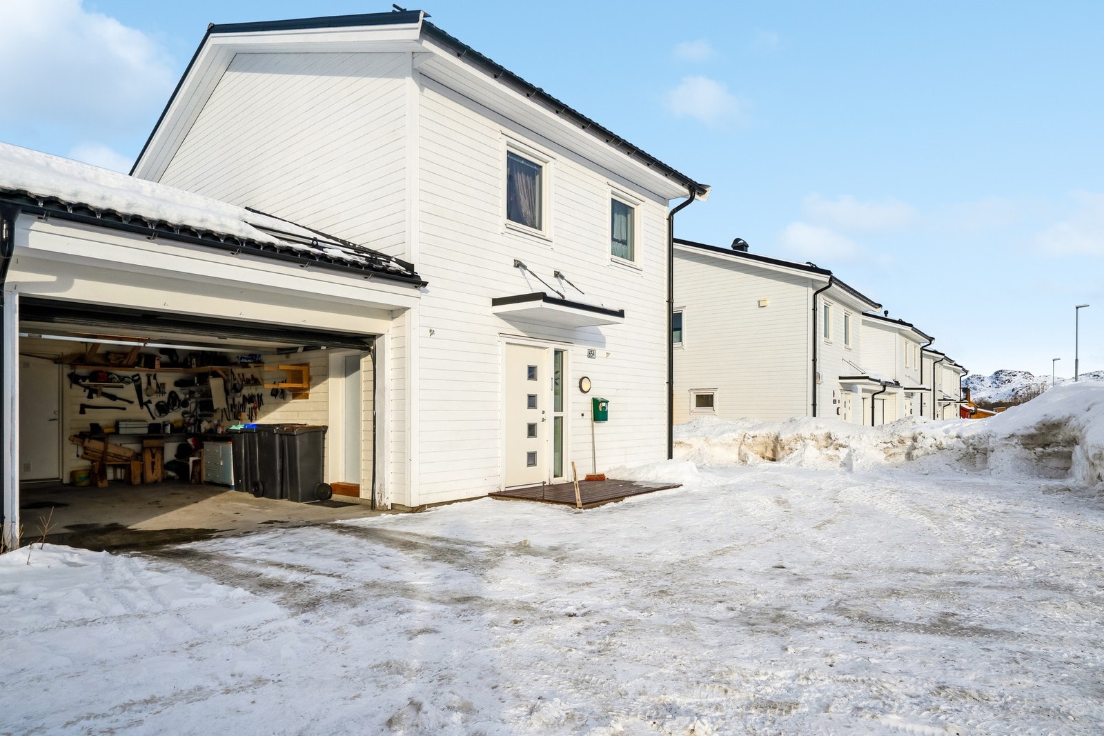 Halvpart av vertikaldelt tomannsbolig med garasje og bod i bakkant av garasjen. Sentral beliggenhet på Ballstad. Galleribilde