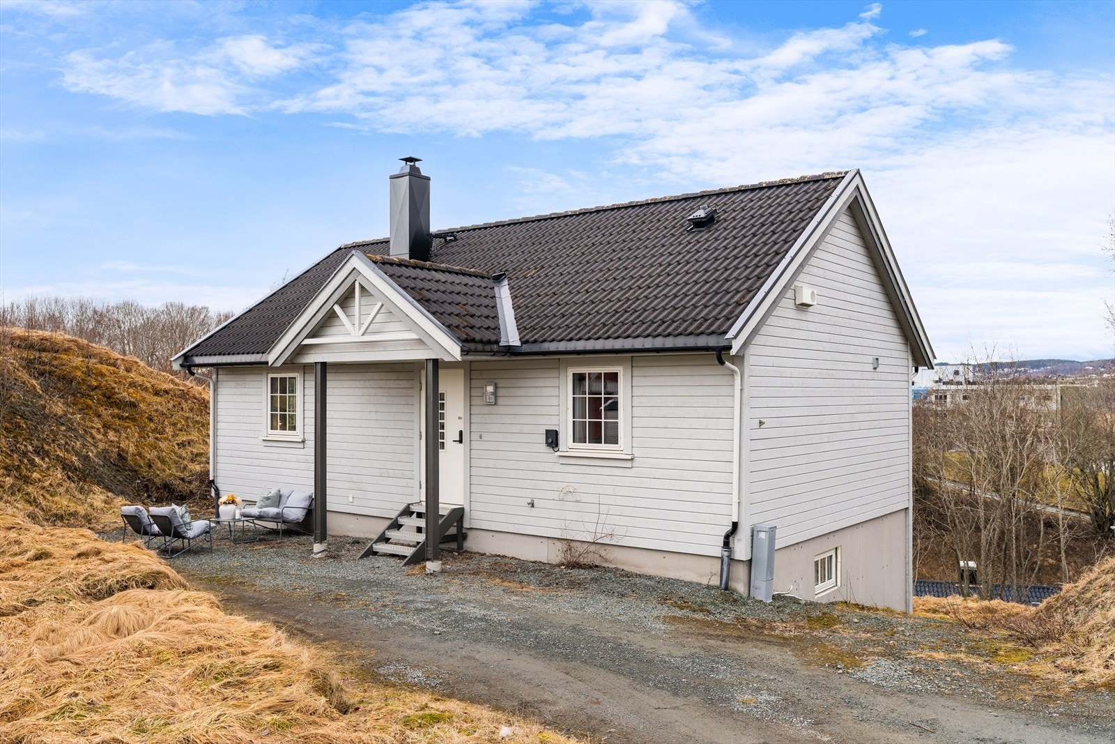 Ved inngangspartiet er det mulighet til å etablere en hyggelig uteplass, og det er biloppstillingsplasser på tomten. Galleribilde