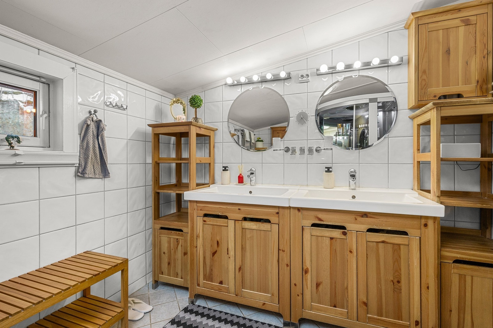 Flislagt bad med dobbel servant og god oppbevaringsplass i innredning fra IKEA. Galleribilde