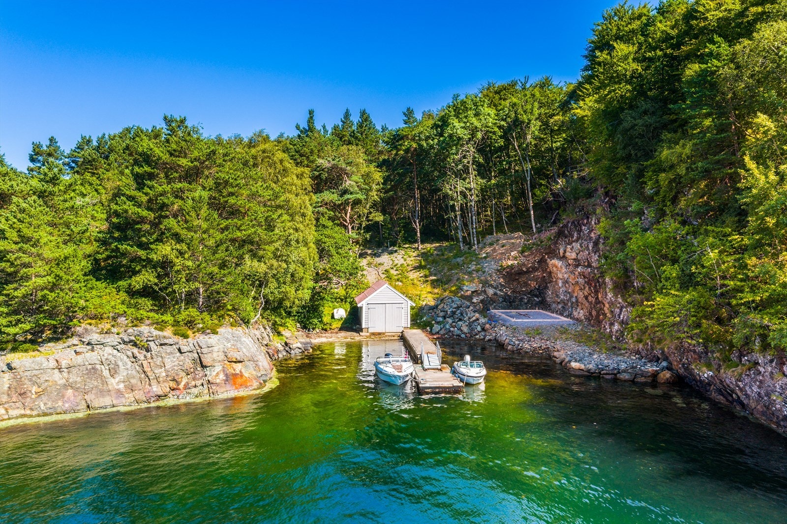 Kun få minutter gange fra ytterdøren kommer du til eget nøst med flytebrygge og mulighet for båt på kjøpet. (Båt til venstre i bilde) Galleribilde