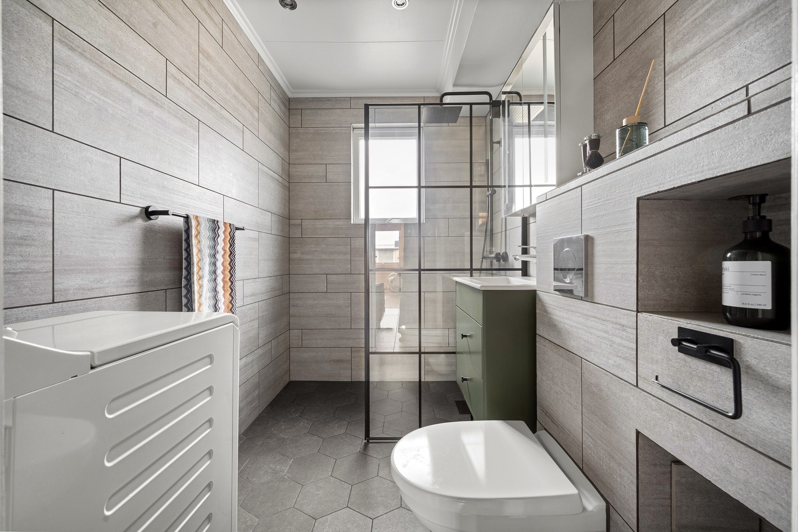 Badet ble rehabilitert i 2021 og har flislagte overflater, gulvvarme og opplegg for vaskemaskin. Galleribilde