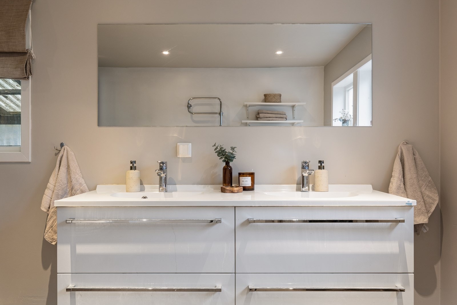 Praktisk innredning med dobbel servant og godt med oppbevaringsplass i skuffer. Galleribilde