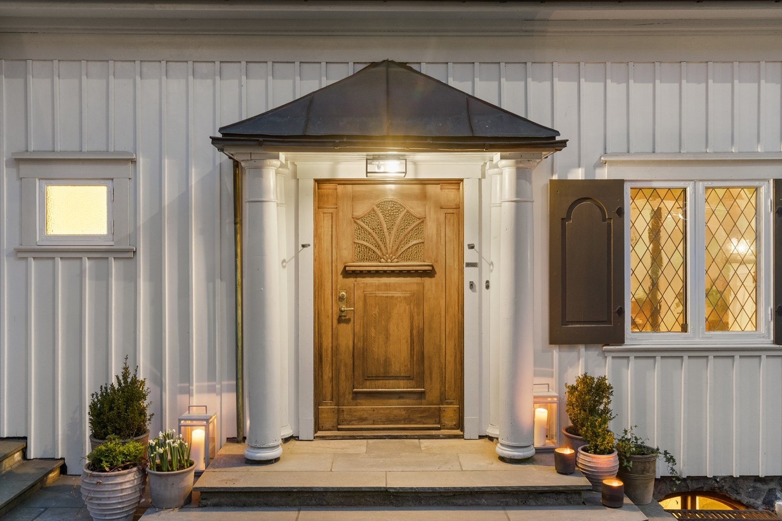 Overbygd inngangsparti med skifertrapp, belysning og lekker eikedør Galleribilde