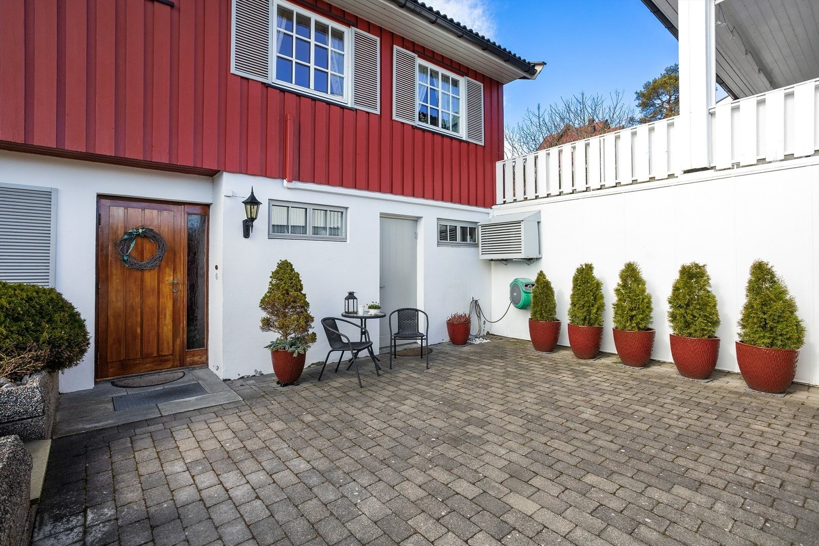 Hyggelig inngangsparti med steinbelagt gårdsplass. Galleribilde