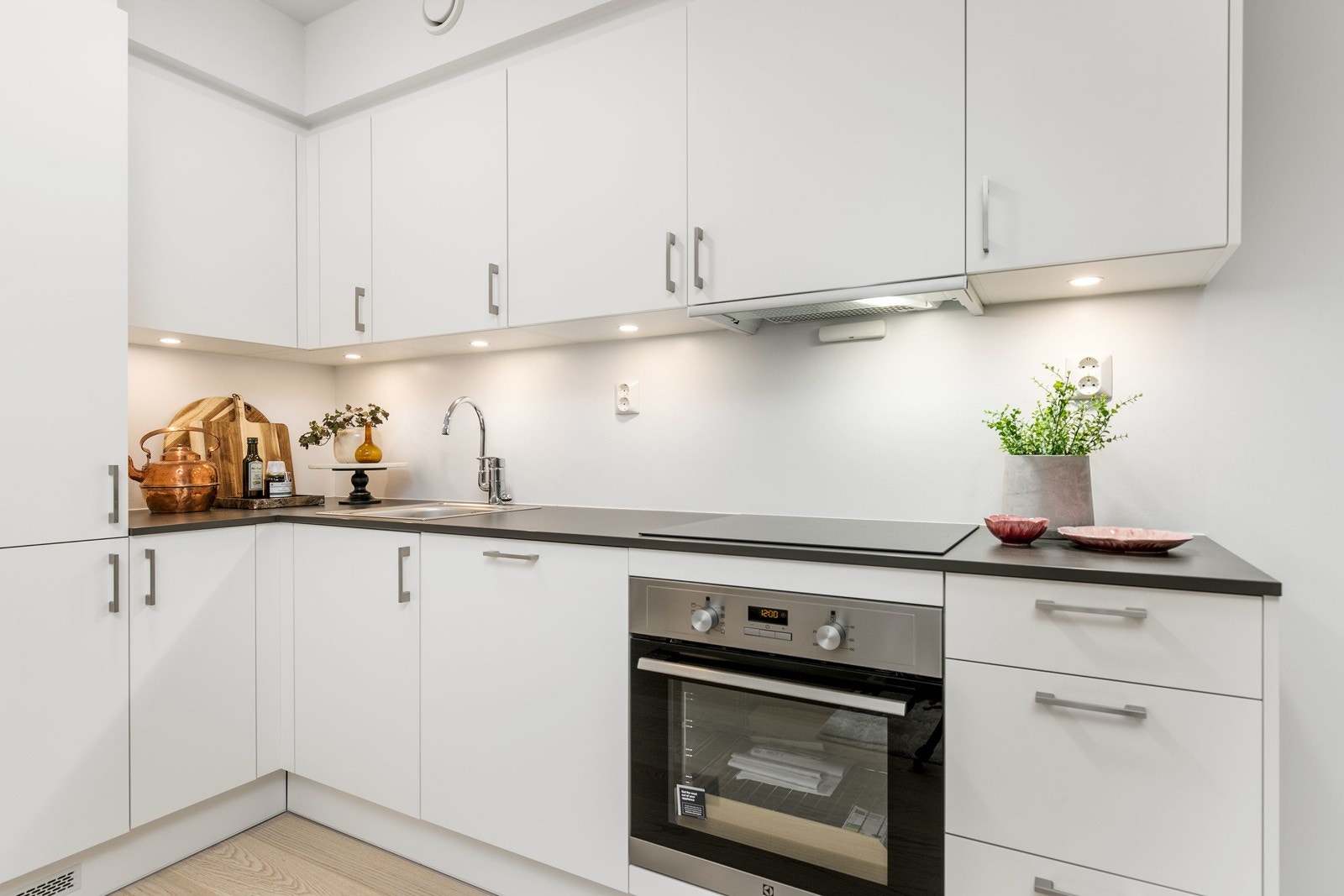 Lekkert kjøkken i åpen løsning mot stuen, med integrerte hvitevarer. Galleribilde