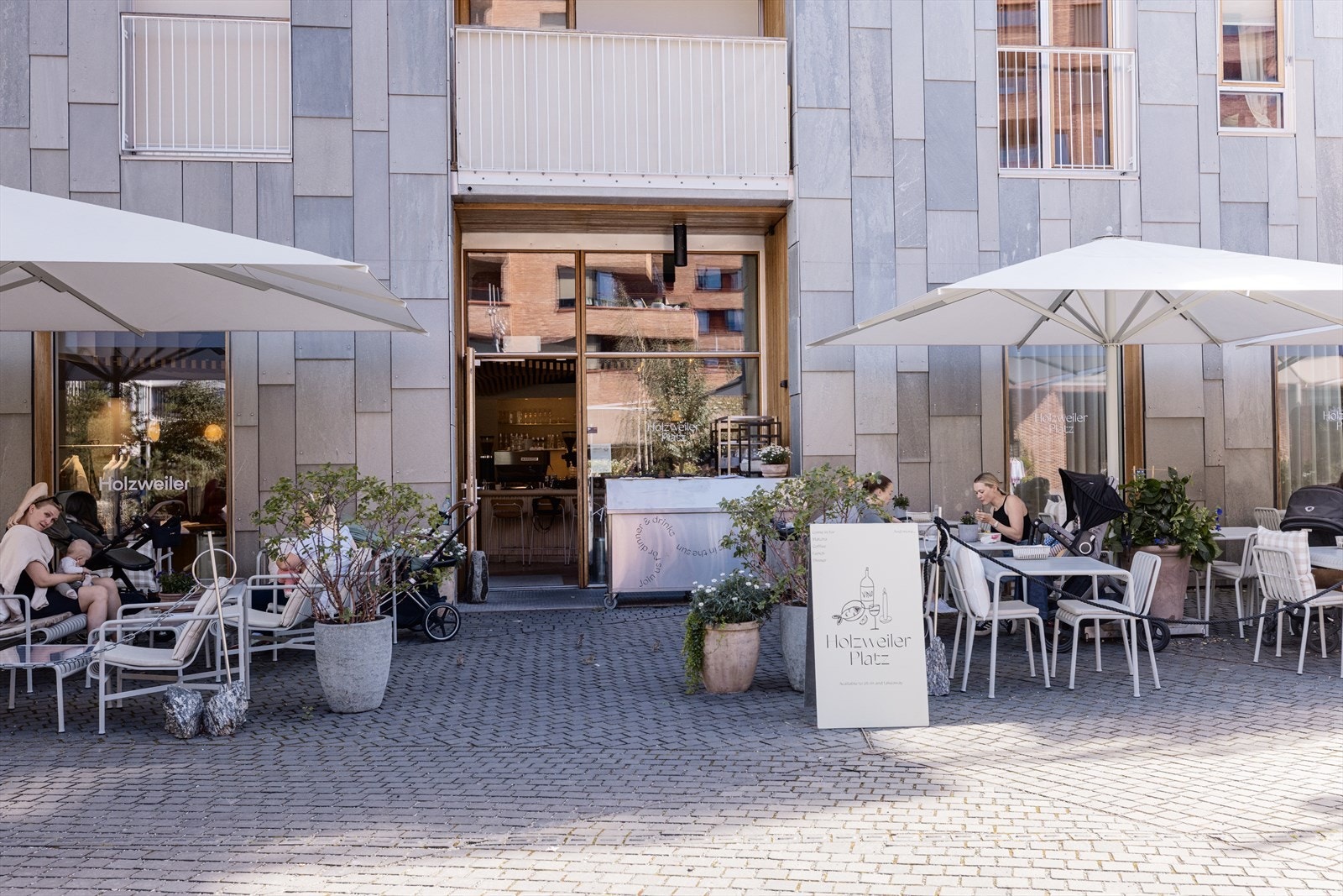 Uteserveringer og sosiale møteplasser preger gatelivet i Bjørvika, Holzweiler Café er en populær nabolagsfavoritt. Galleribilde