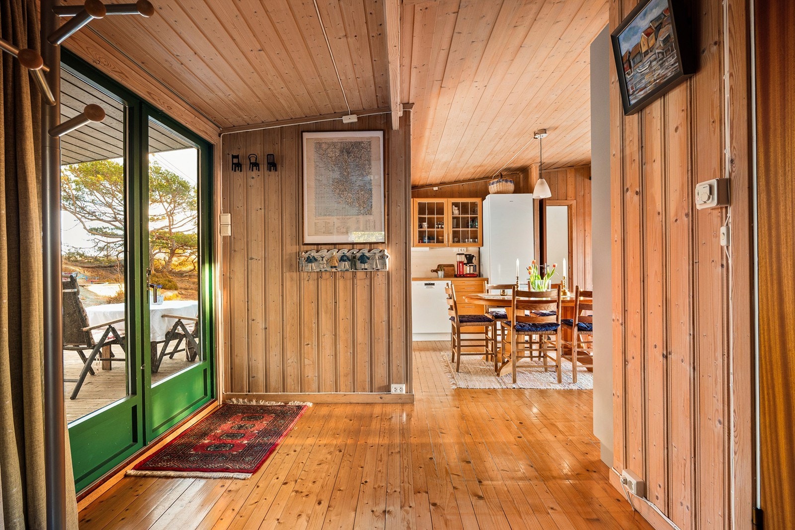 Fra kjøkkenet kan frokostene og kaffekoppen meget enkelt tas med ut i morgensolen på inngangssiden. Galleribilde