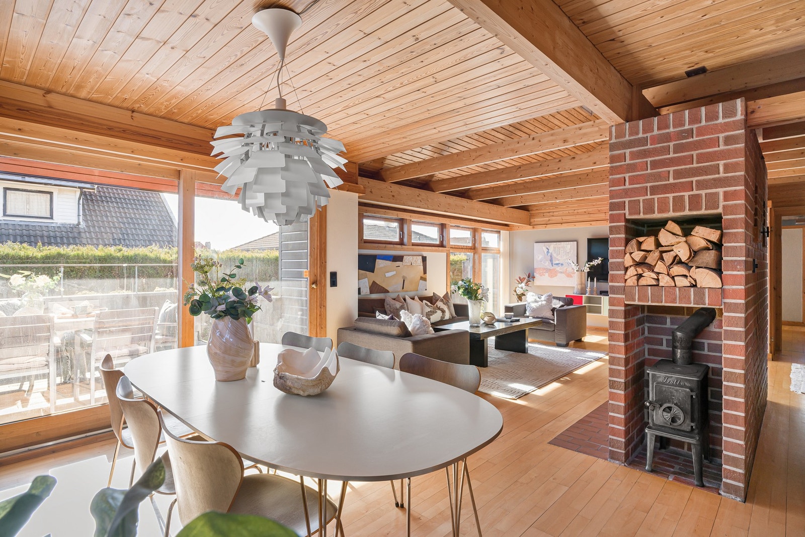 Åpen stue- og kjøkkenløsning der kjøkkenet er skjermet fra deler av stuen Galleribilde