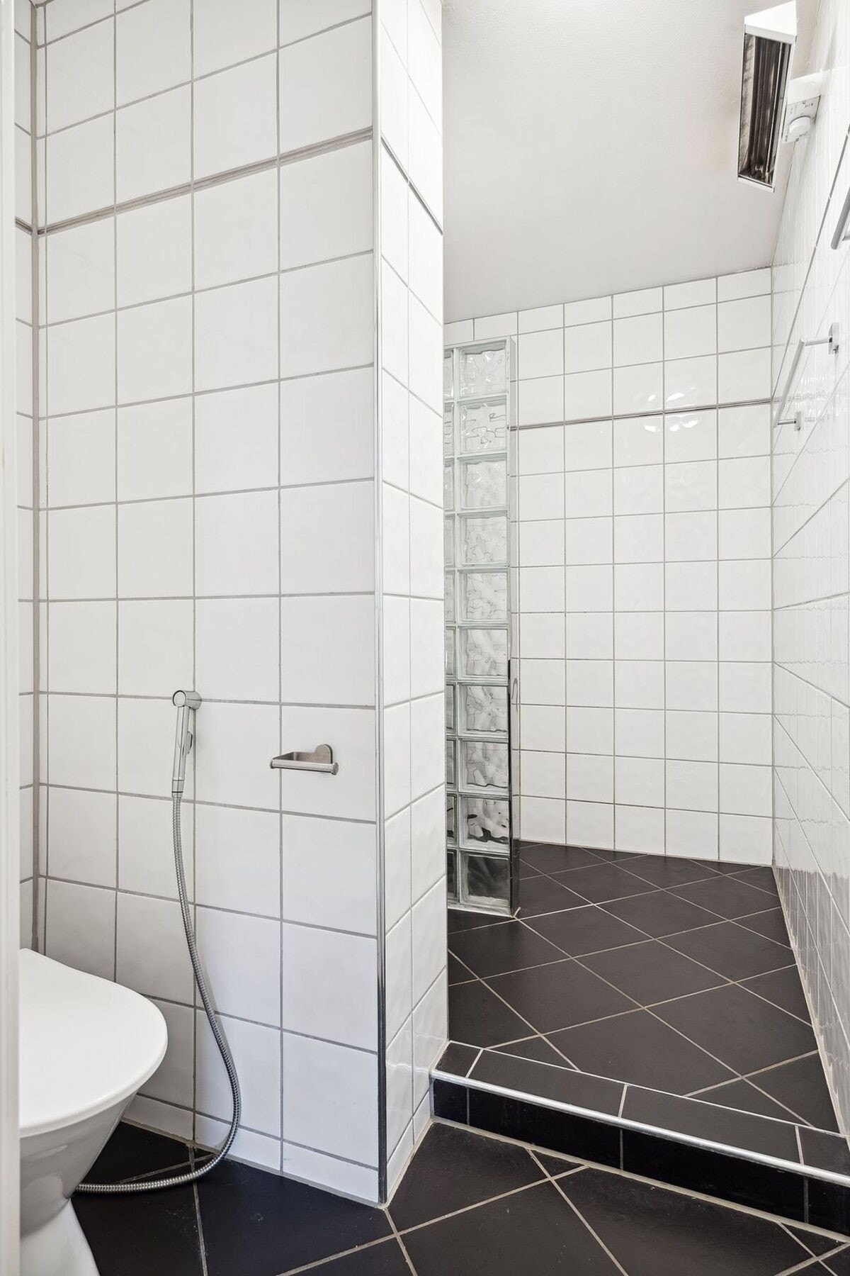 Badet er flislagt og fremstår funksjonelt og stilrent. Galleribilde