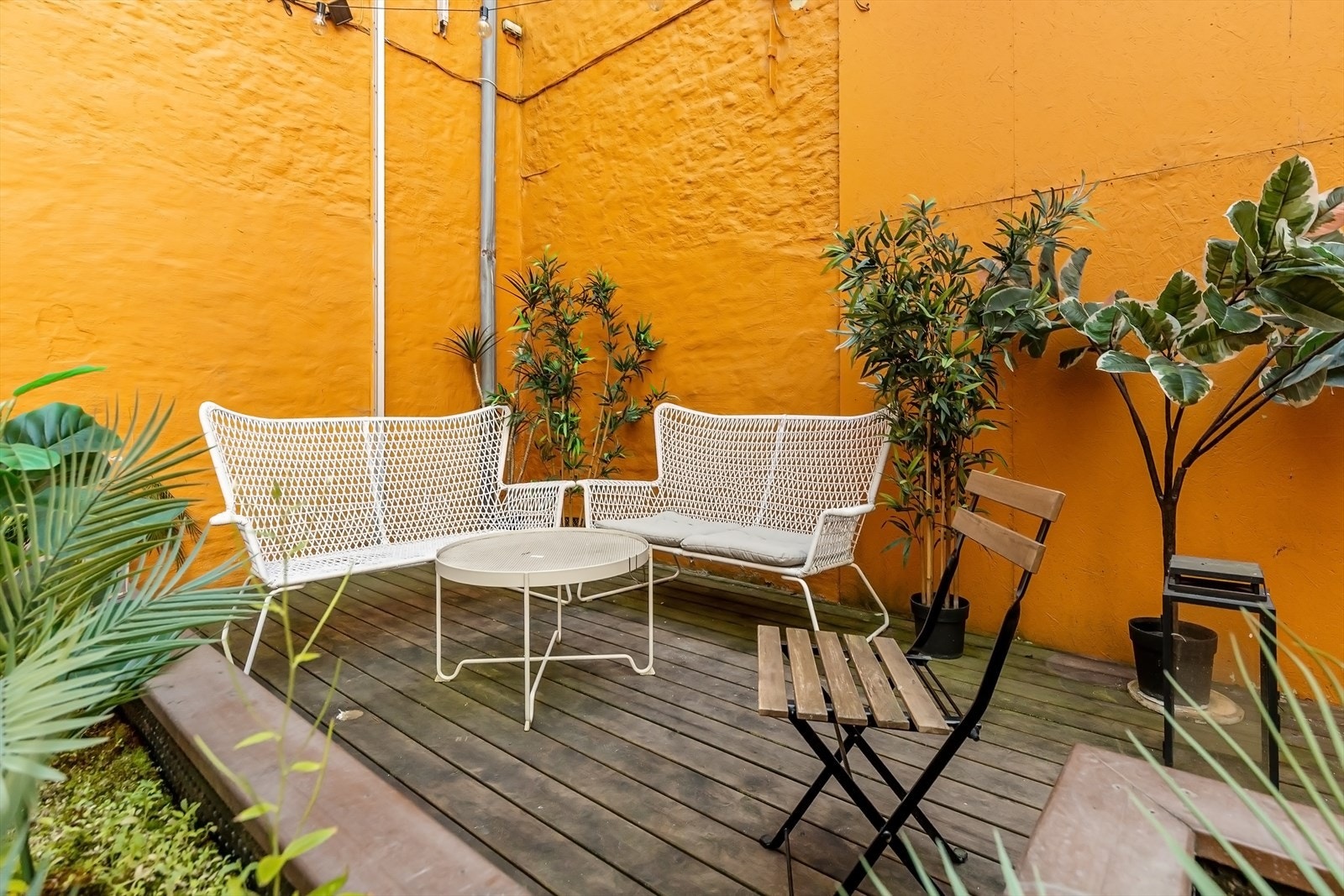 Bakgården har en opphøyet terrasseplatting med sittegruppe. Galleribilde