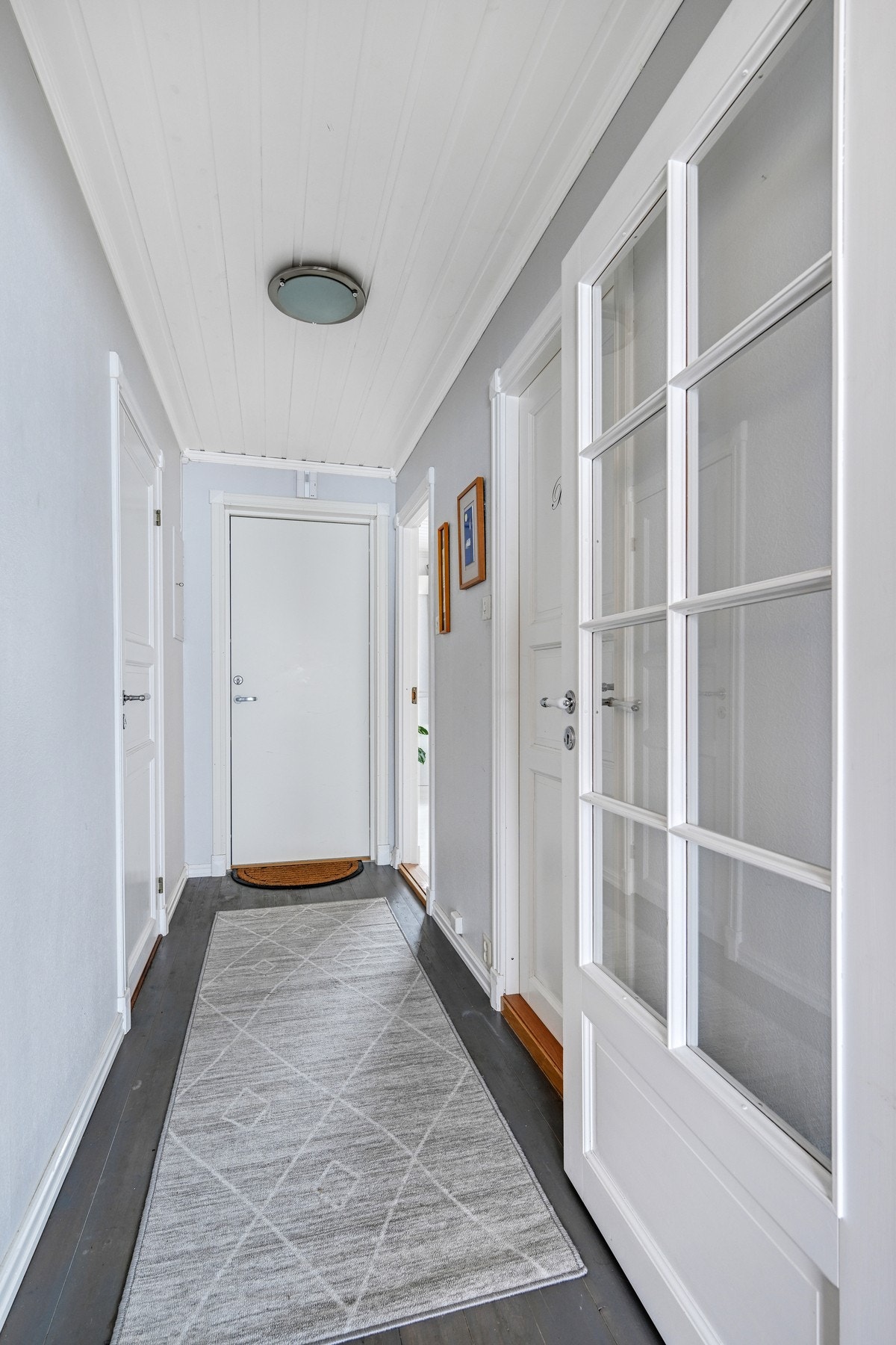 Velkommen inn i en behagelig gang med lyse toner. Fra inngangsdøren, er det direkte utsyn mot stuevinduene og utsikten Galleribilde