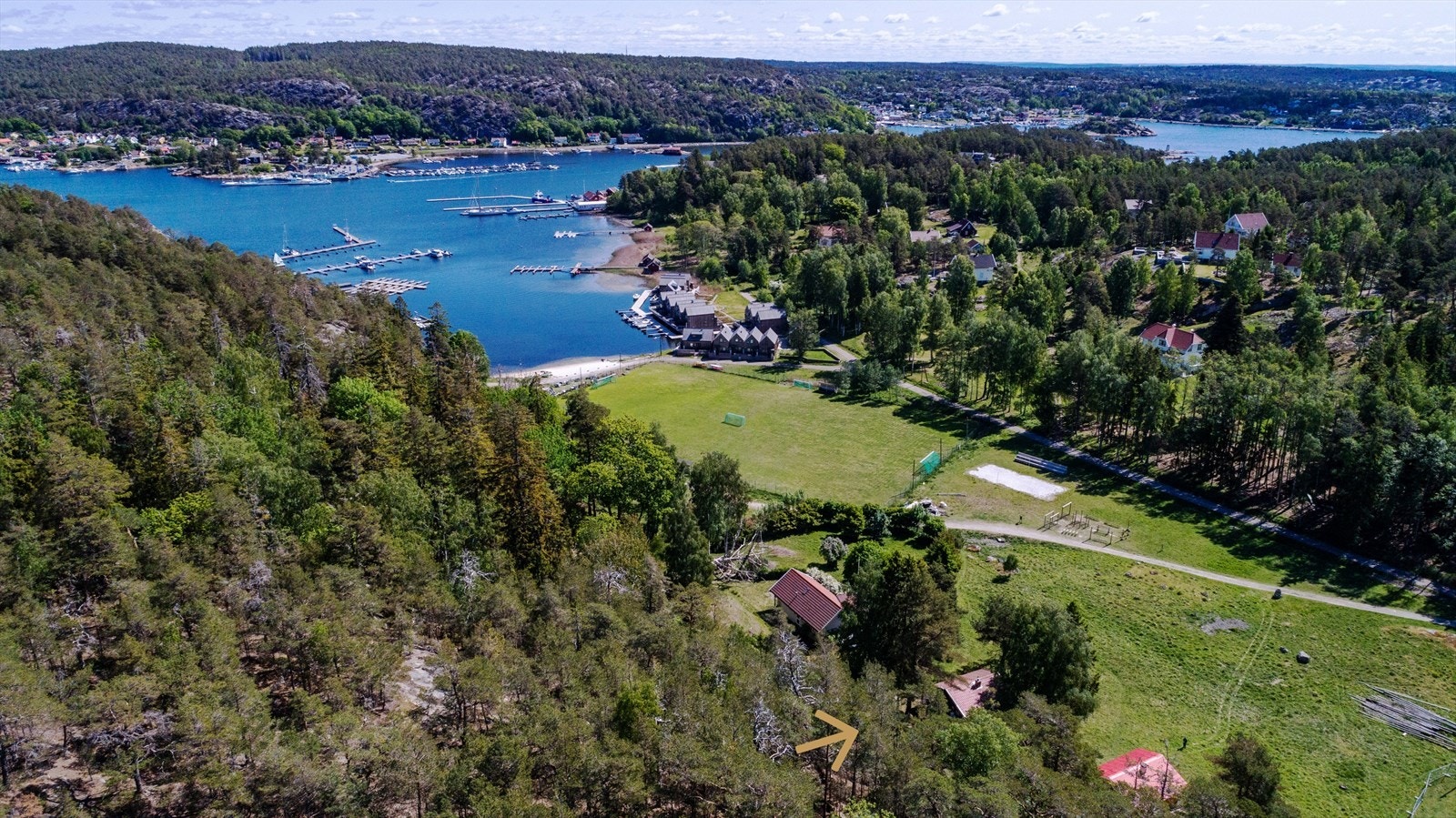 Hytta ligger kort fra Varmbadbukta, og har egen båtplass. Den ligger skjermet av furu og bjørk mot en stor slette - en fin, åpen aktivitetsplass på vei ned mot stranda. Foto: Steffen Larsen. Galleribilde