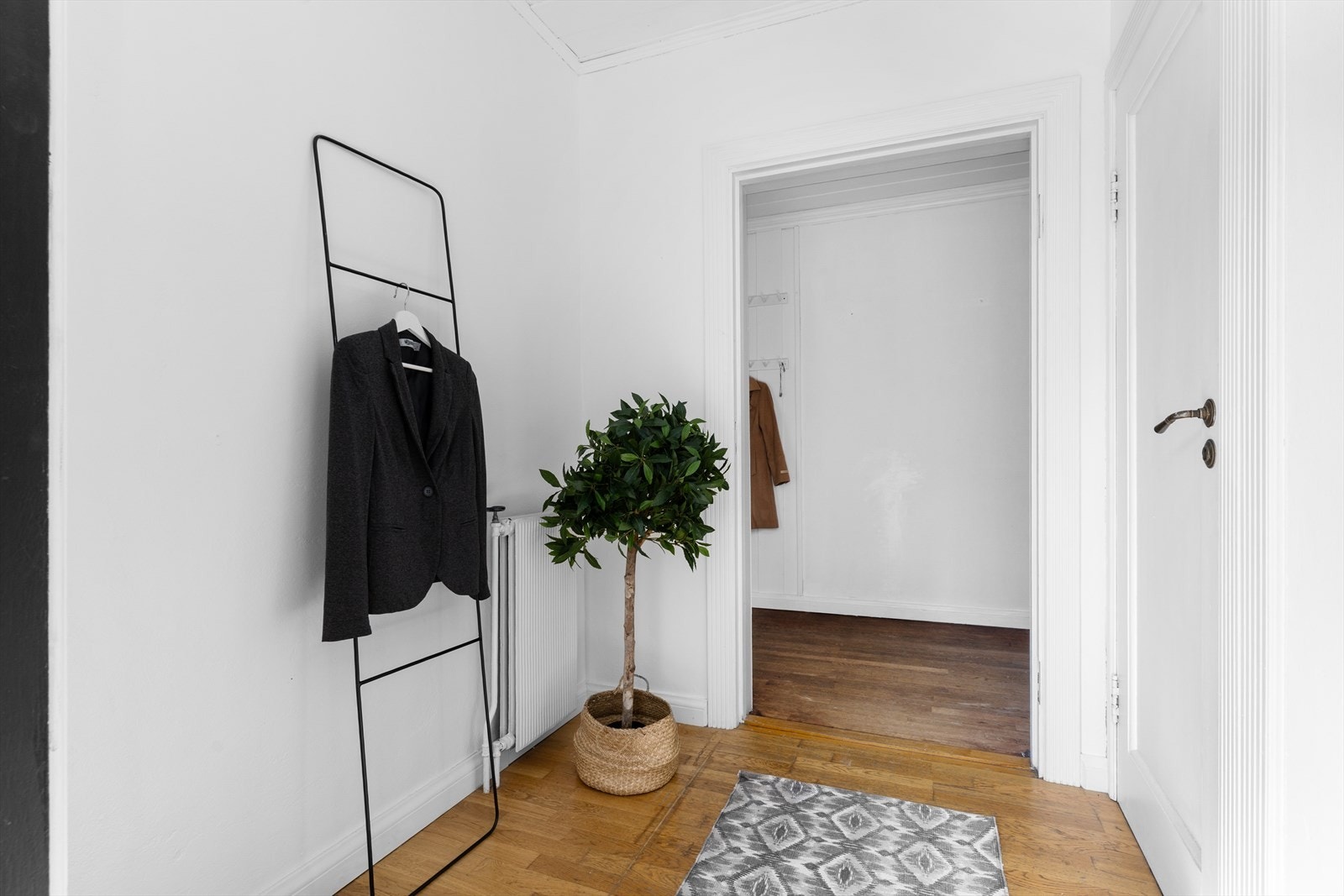 Velkommen inn! Til en lys gang med muligheter til å henge fra seg klær. Galleribilde