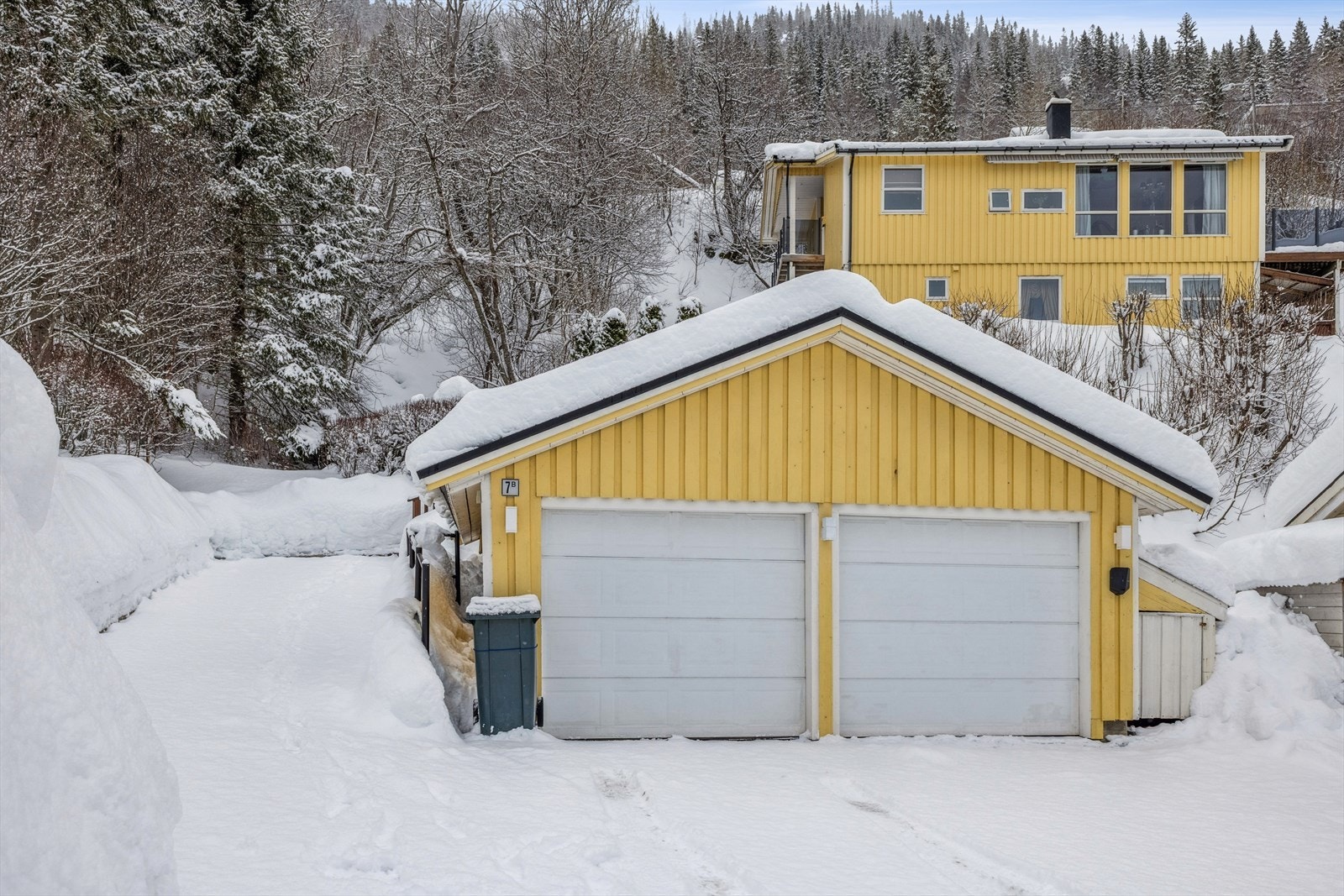 Garasjen har innmonterte leddporter, hvorav en med portåpner, og er utstyrt med lys og stikkontakt samt billader. Galleribilde