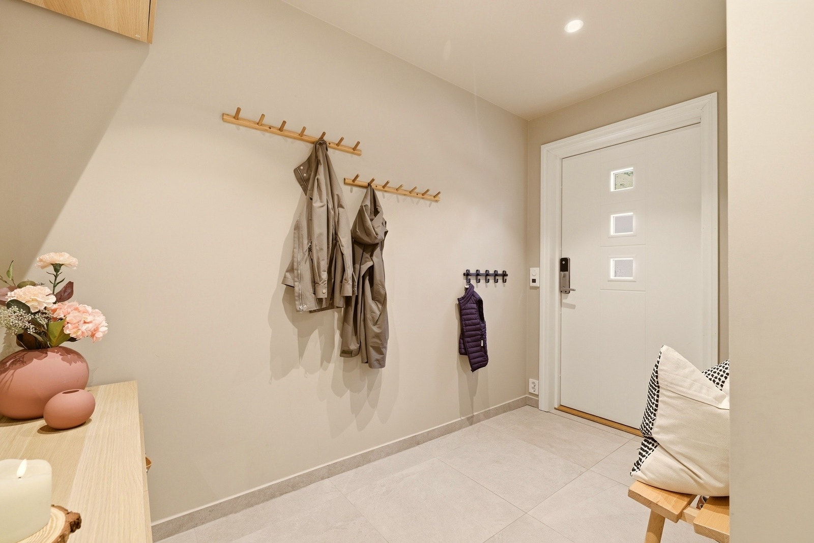 Velkommen inn | Denne romslige hallen er fra 2023 | Her er det godt med plass til sko og yttertøy | Nyere hoveddør med kodelås Galleribilde