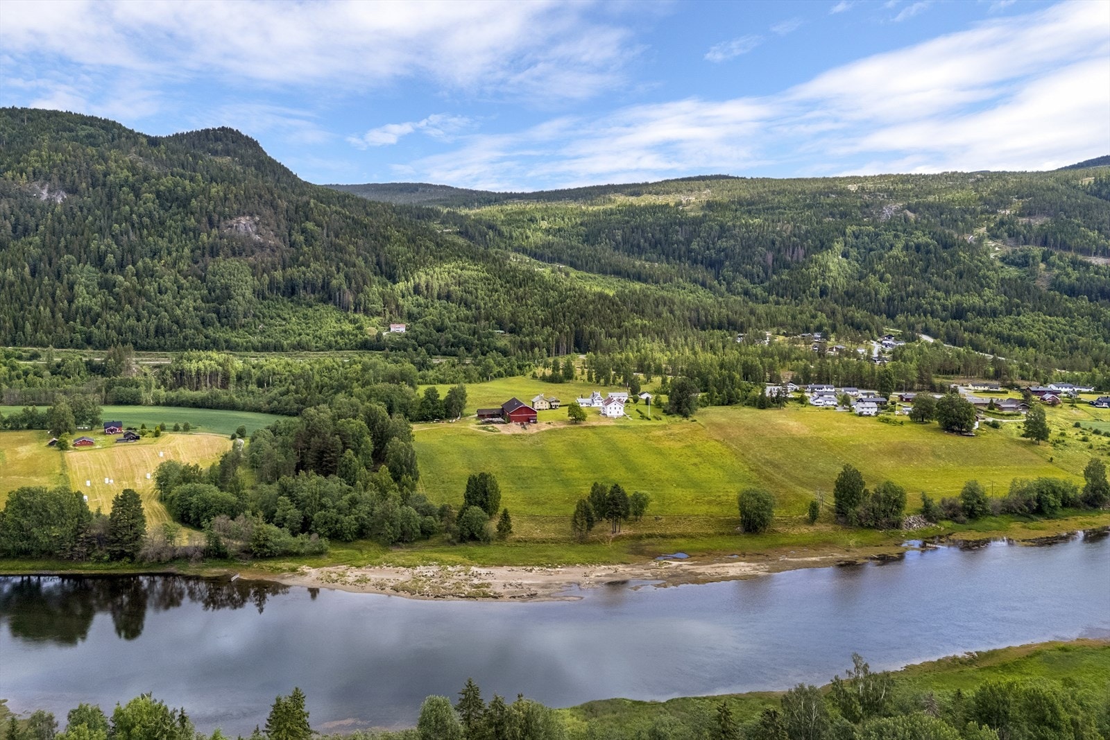 Dyrket mark ligger mellom Austsidevegen og Hallingdalselva med svake hellinger og gode solforhold Galleribilde