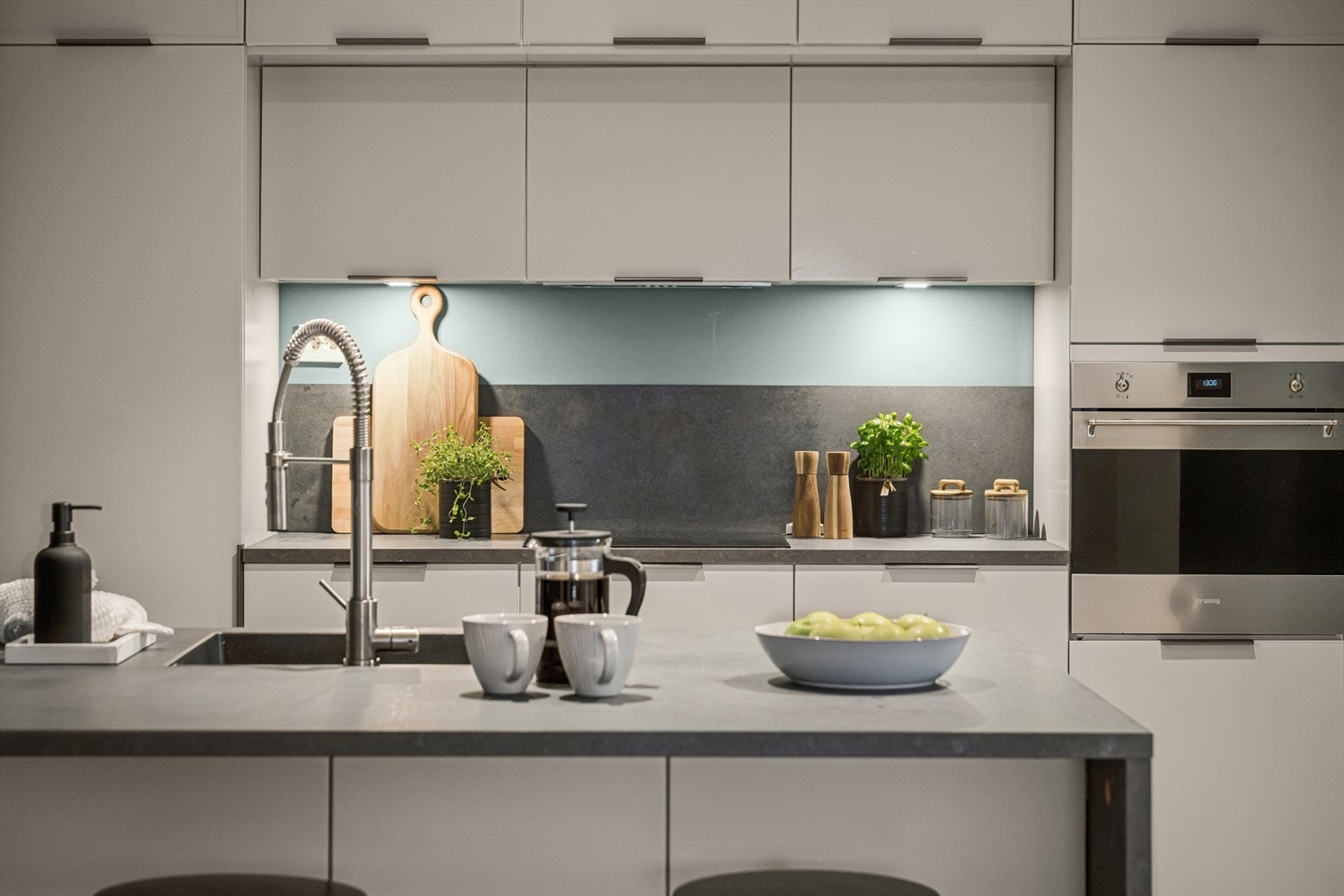 Moderne kjøkkeninnredning med integrerte hvitevarer: Komfyr, koketopp, oppvaskmaskin, ventilator, kjøl- og fryeskap Galleribilde