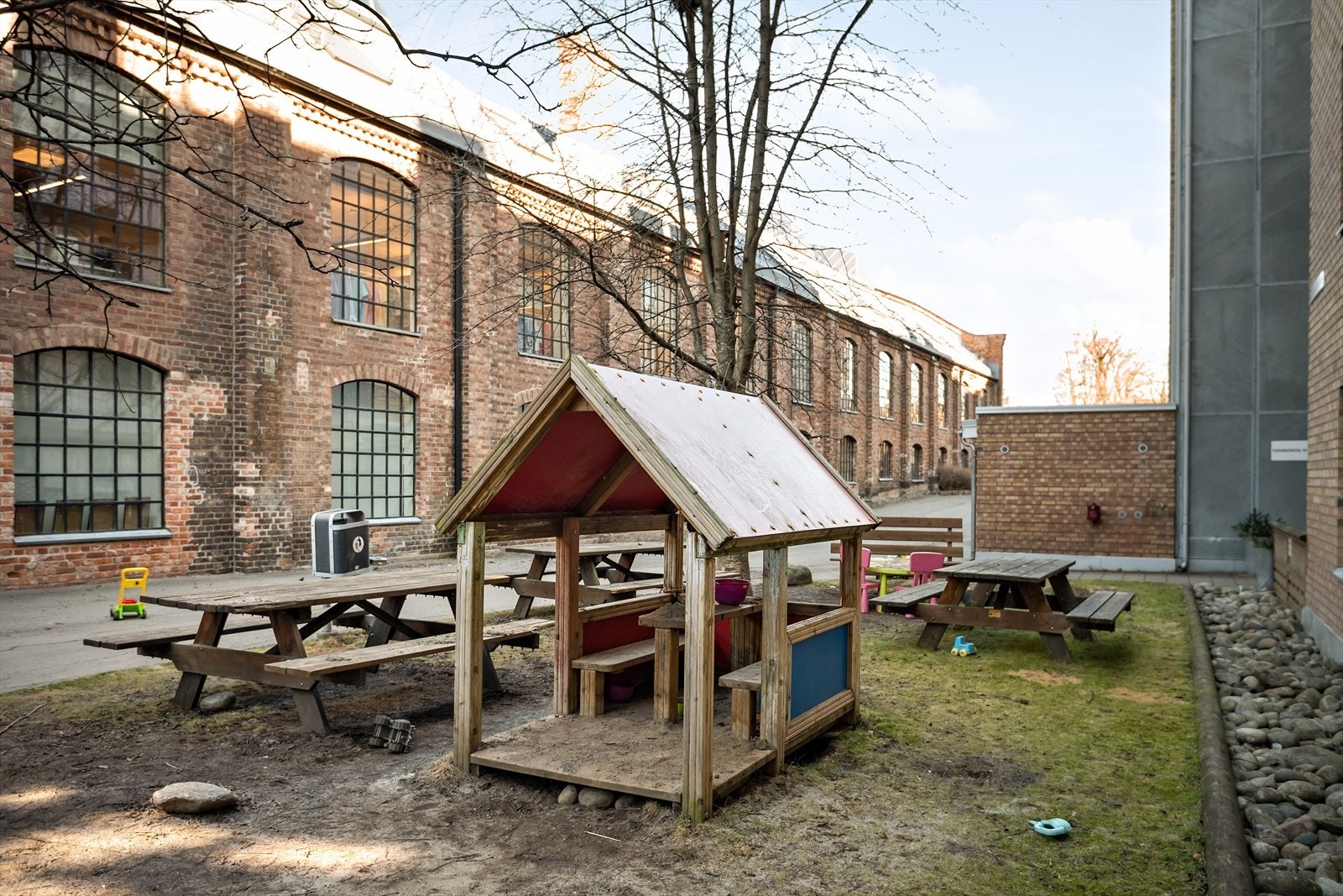 Felles uteområde med sitteplasser og lekeapparat utenfor Galleribilde