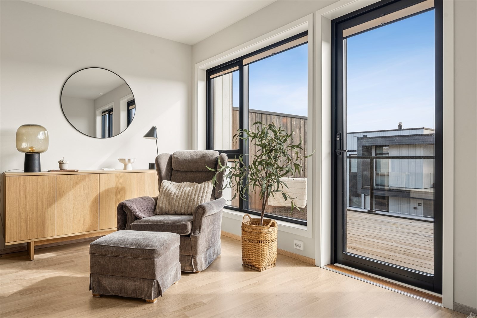 De store vinduene og balkongdøren gir rikelig med dagslys til oppholdsrommet. Galleribilde