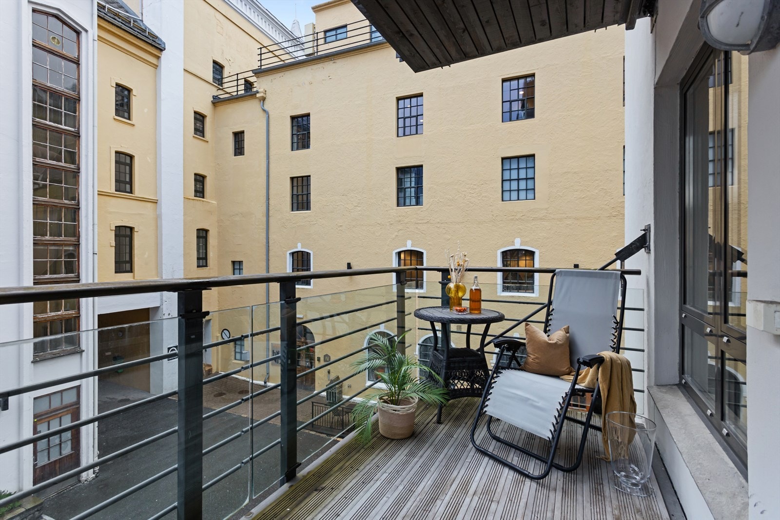 Balkongen er 7 kvm og har rekkverk i glass og tredekke. Galleribilde