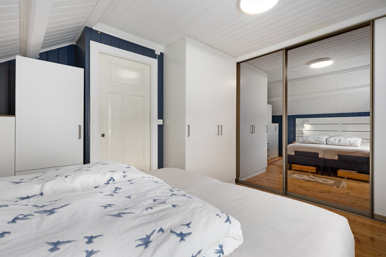 Stort hovedsoverom med flotte skyvedørsgarderober. Galleribilde