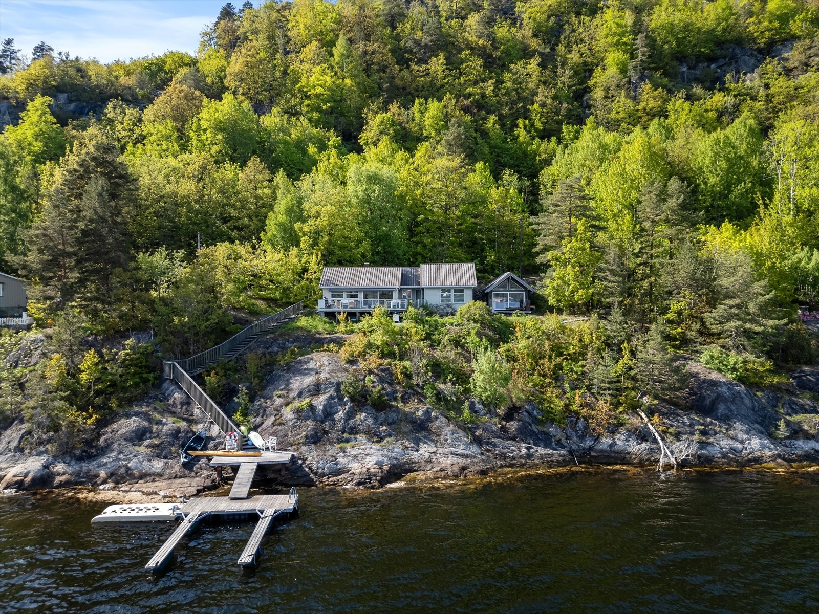 Hytta ligger i usjenerte omgivelser. Det er kun den innerste delen av brygga som står på eiendommen i dag. Flytebrygge og utliggere er fjernet etter bildene ble tatt. Galleribilde