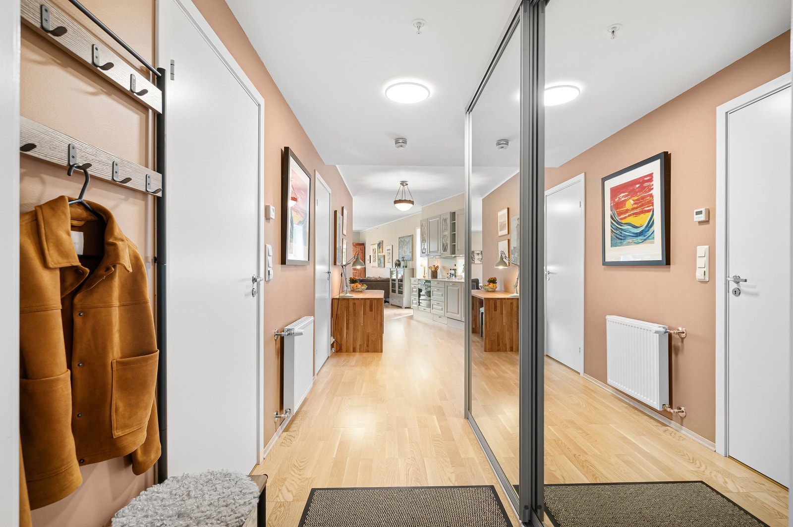 Rosmlig entrè med en skyvedørsgarderobe som medfølger handelen. Galleribilde