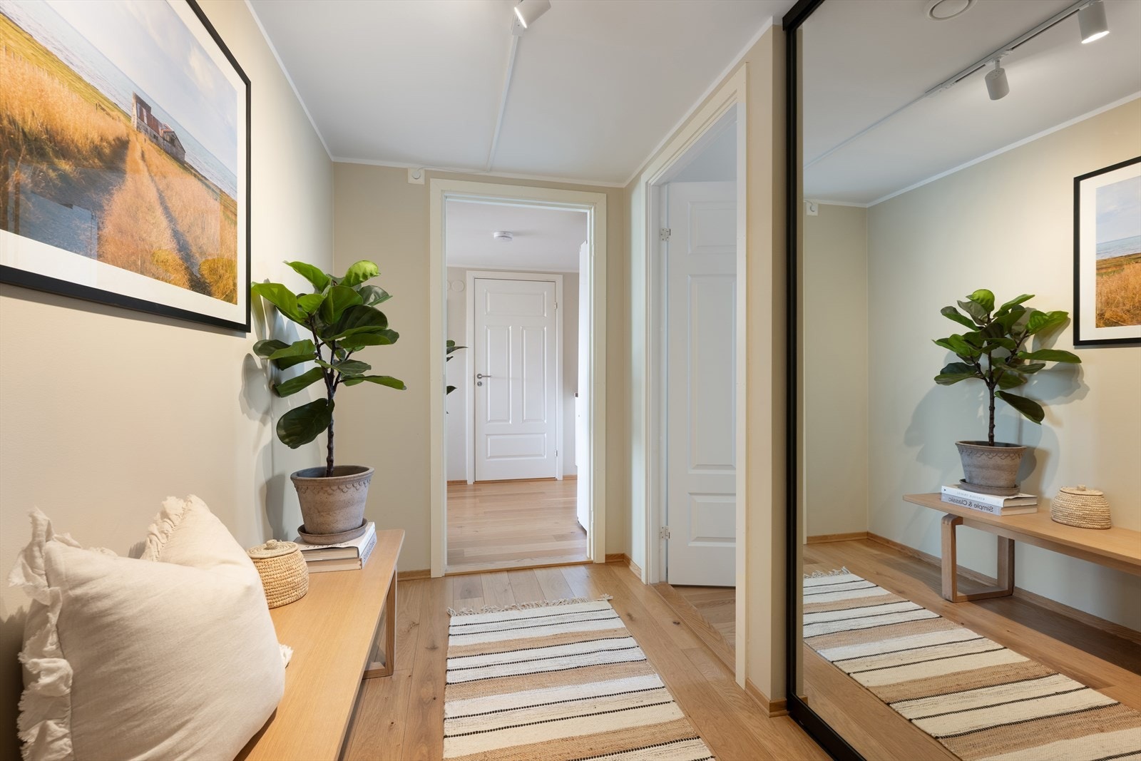 Lys og innbydende entré hvor du raskt vil legge merke til leilighetens høye standard med gulvflater bestående av elegant enstavs parkett, som harmonerer utmerket mot veggflatene som er malt opp i en delikat sandtone Galleribilde