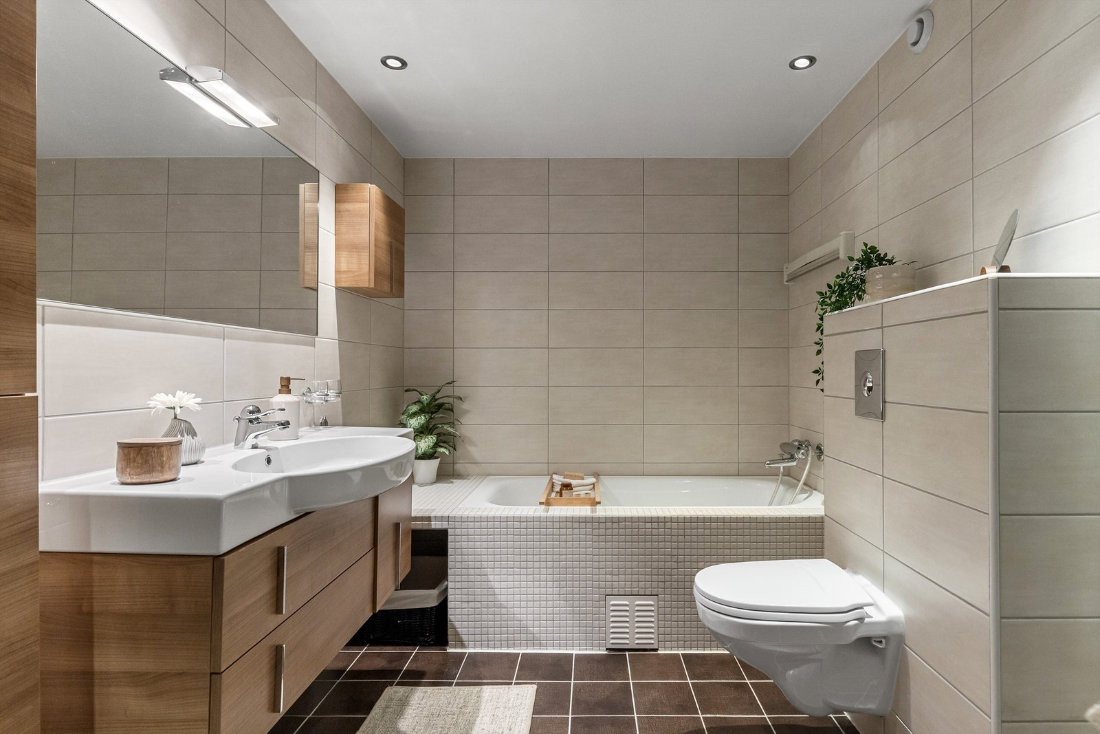 Pent bad med innmurt badekar og dusjnisje med svingbare glassdører Galleribilde