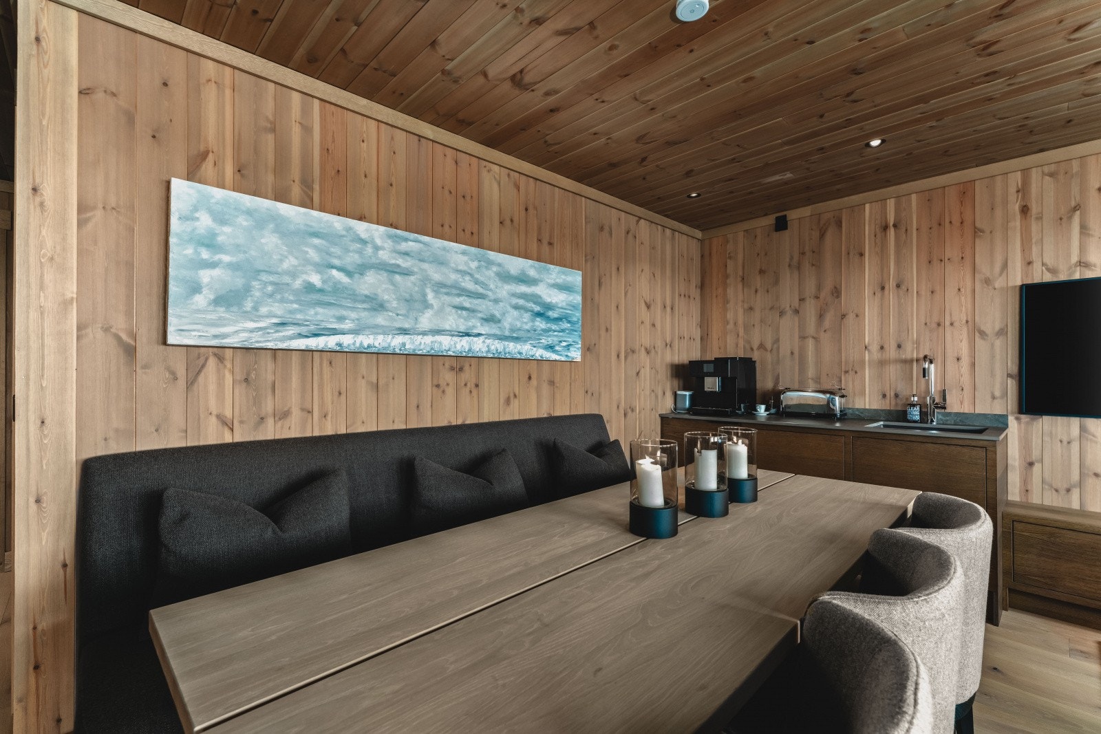 I hjørnet er det en praktisk og stilren kjøkkenbenk med kjøleskap, servant og kaffemaskin, slik at man enkelt kan servere noe godt uten å måtte gå opp i hovedetasjen. Galleribilde