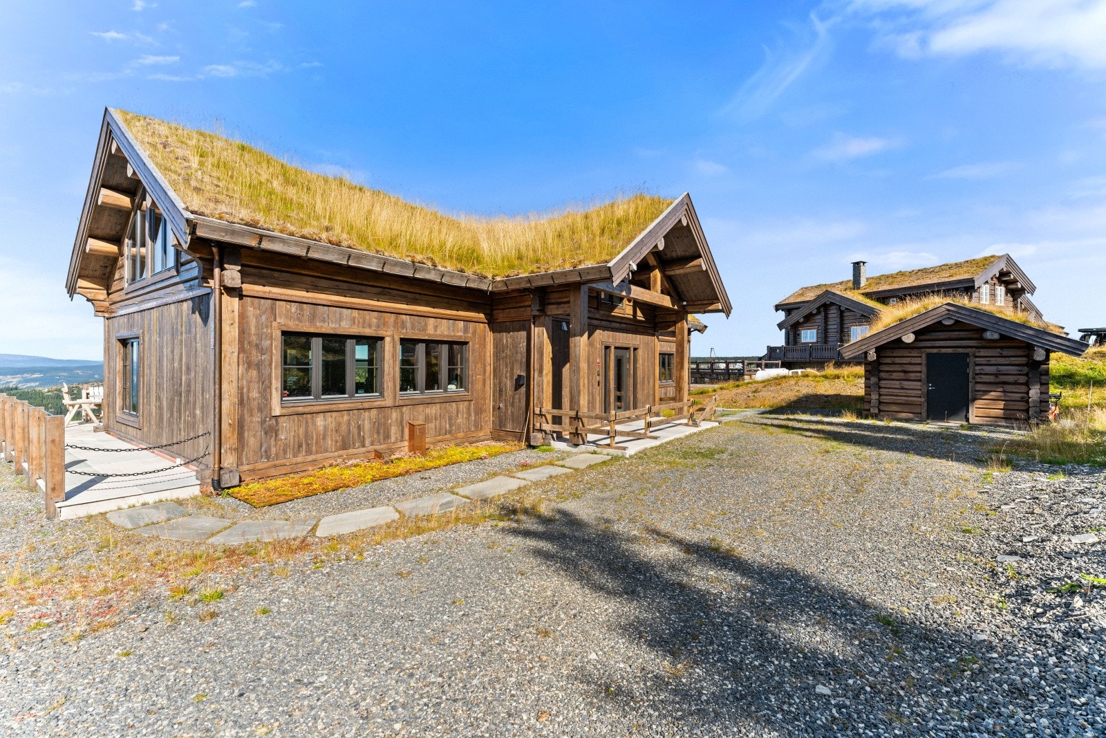 Romslig gårsplass med praktisk adkomst til begge terrassene, overbygg over inngangsparti og plass for flere biler Galleribilde