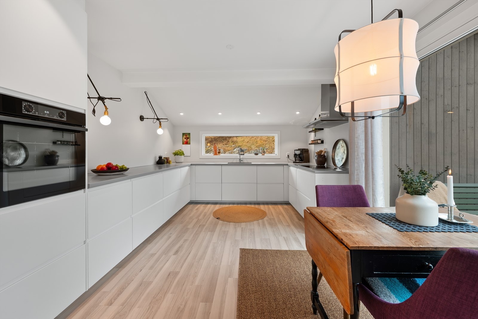 Innredningen har glatte fronter og er utstyrt med integrert kjøleskap, oppvaskmaskin, komfyr og platetopp. Galleribilde