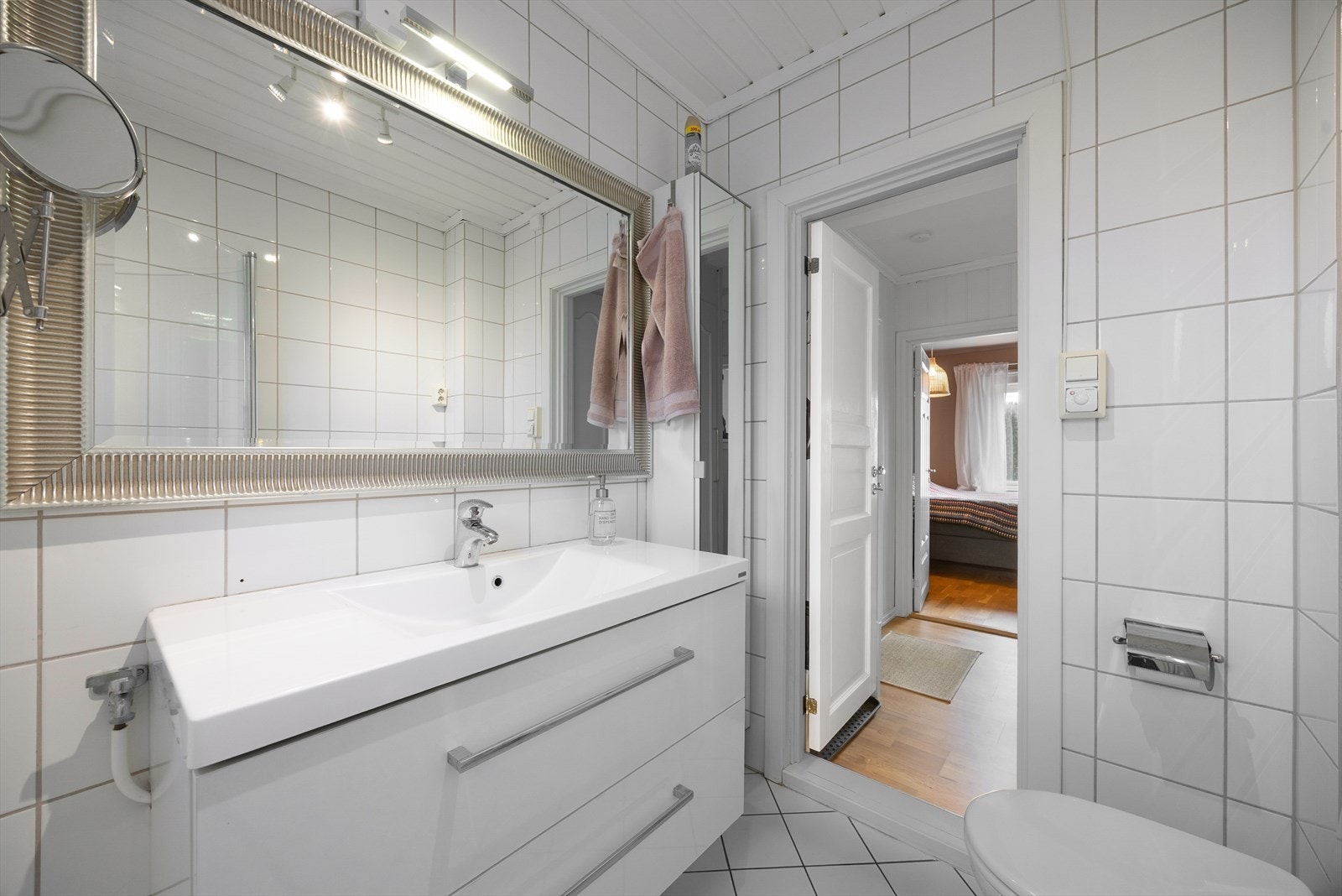 På vegg over innredningen er det montert stort speil og overlys, samt praktiske sideskap med ytterligere oppbevaringsplass. Galleribilde