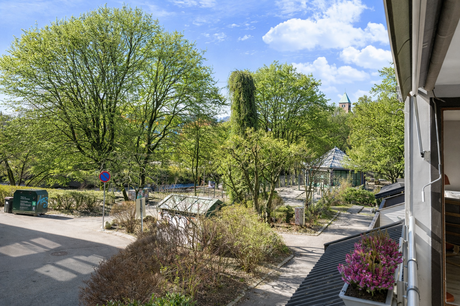 Leiligheten vender ut mot enveiskjørt gate med utsyn mot grønne omgivelser. Bilde redigert med AI. Det tas forbehold om at avvik kan forekomme. Galleribilde